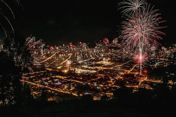 Cityscape Illuminated by Massive Fireworks Celebration