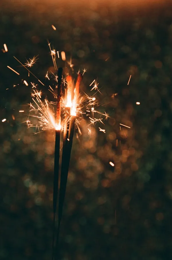 Close up of a Sparkler Glowing Brightly in the Darkness