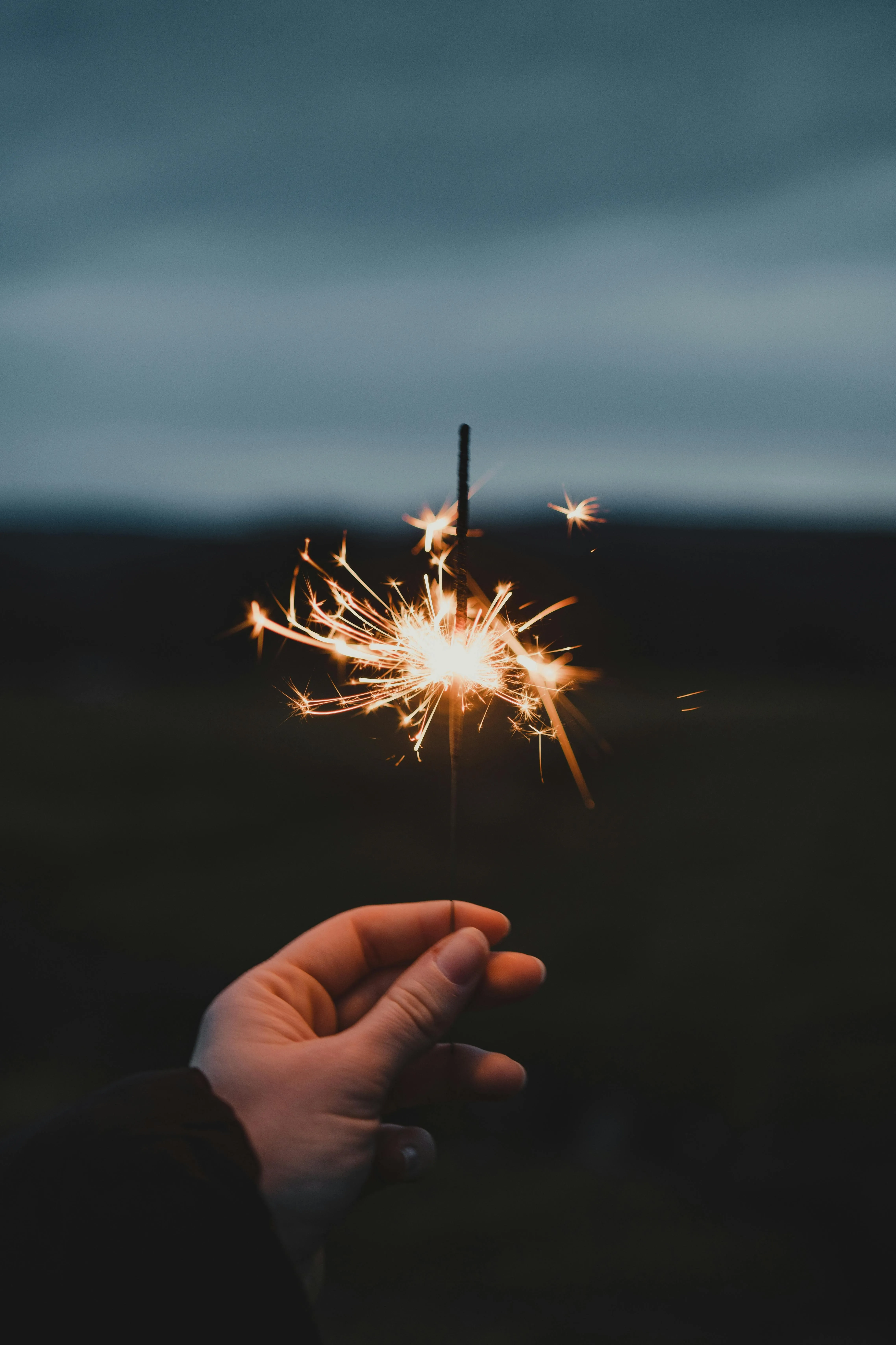 Close up of Sparkler Lighting up the Night Sky Wallpaper