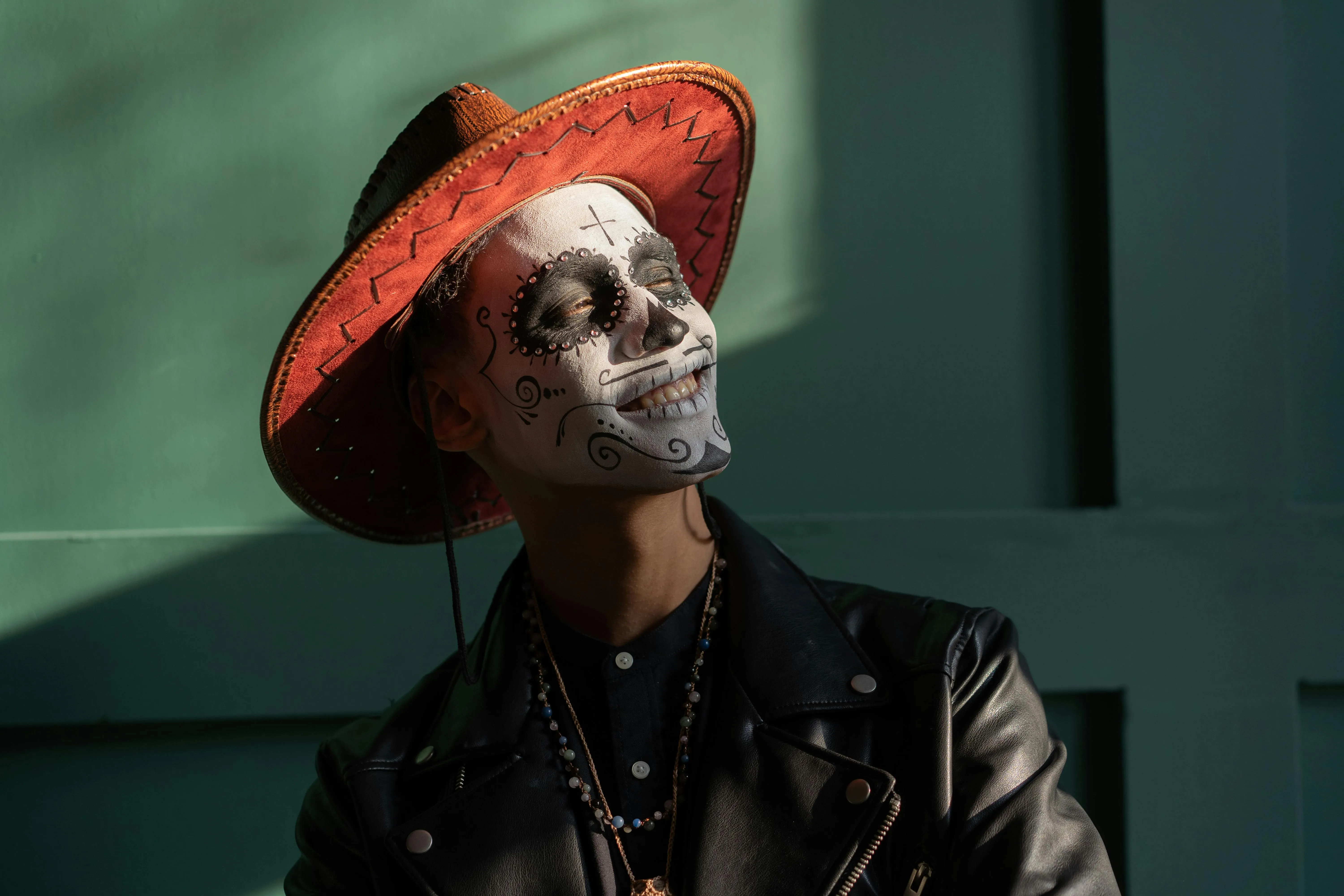 CloseUp of Man with Skeleton Face Paint and Hat HD image