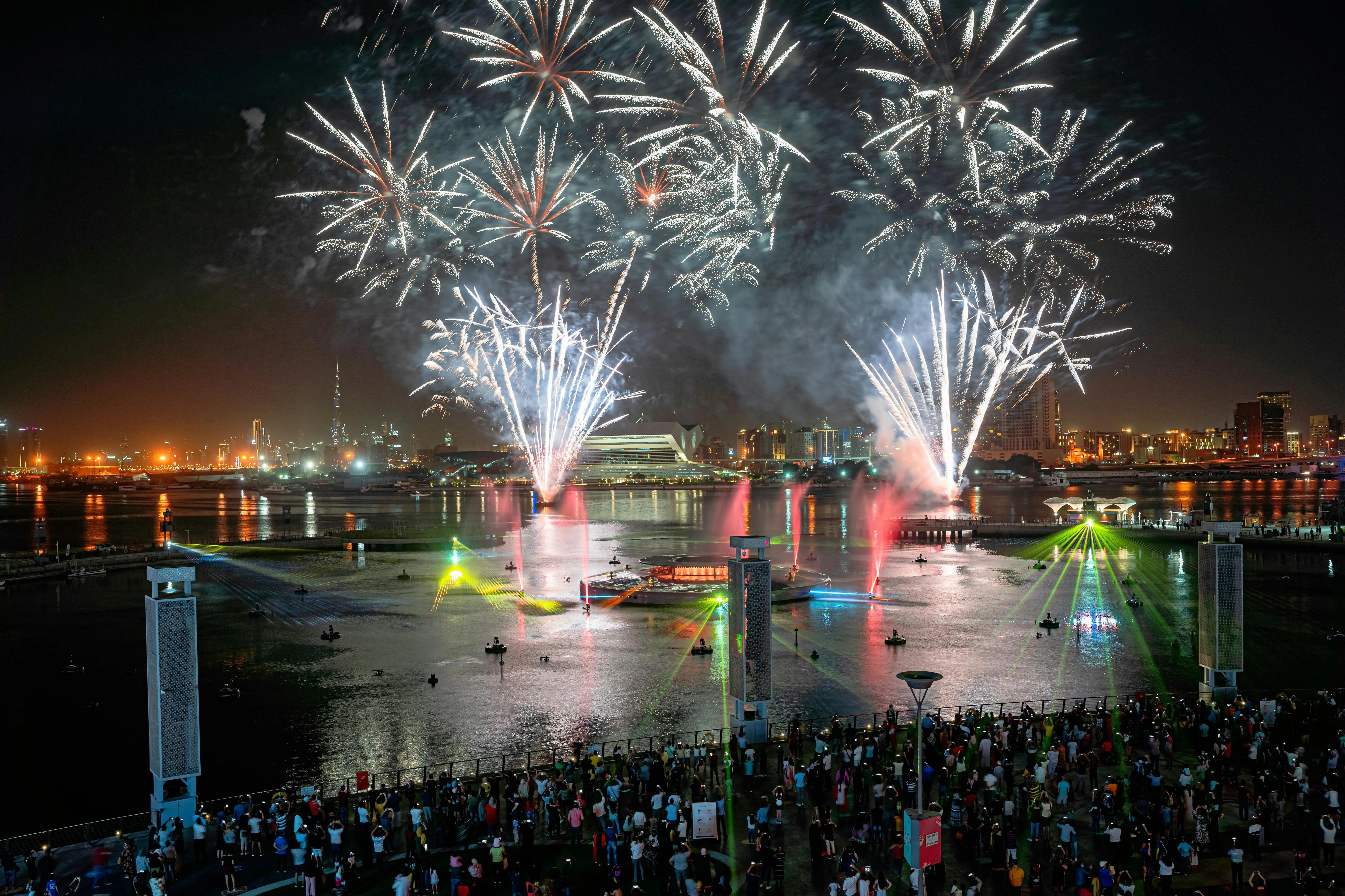 Colorful Fireworks above a Waterfront Celebration Wallpaper