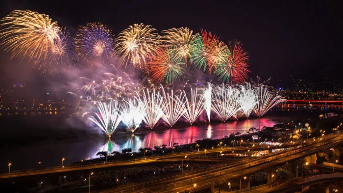 Colorful Fireworks Display above a City by the Water