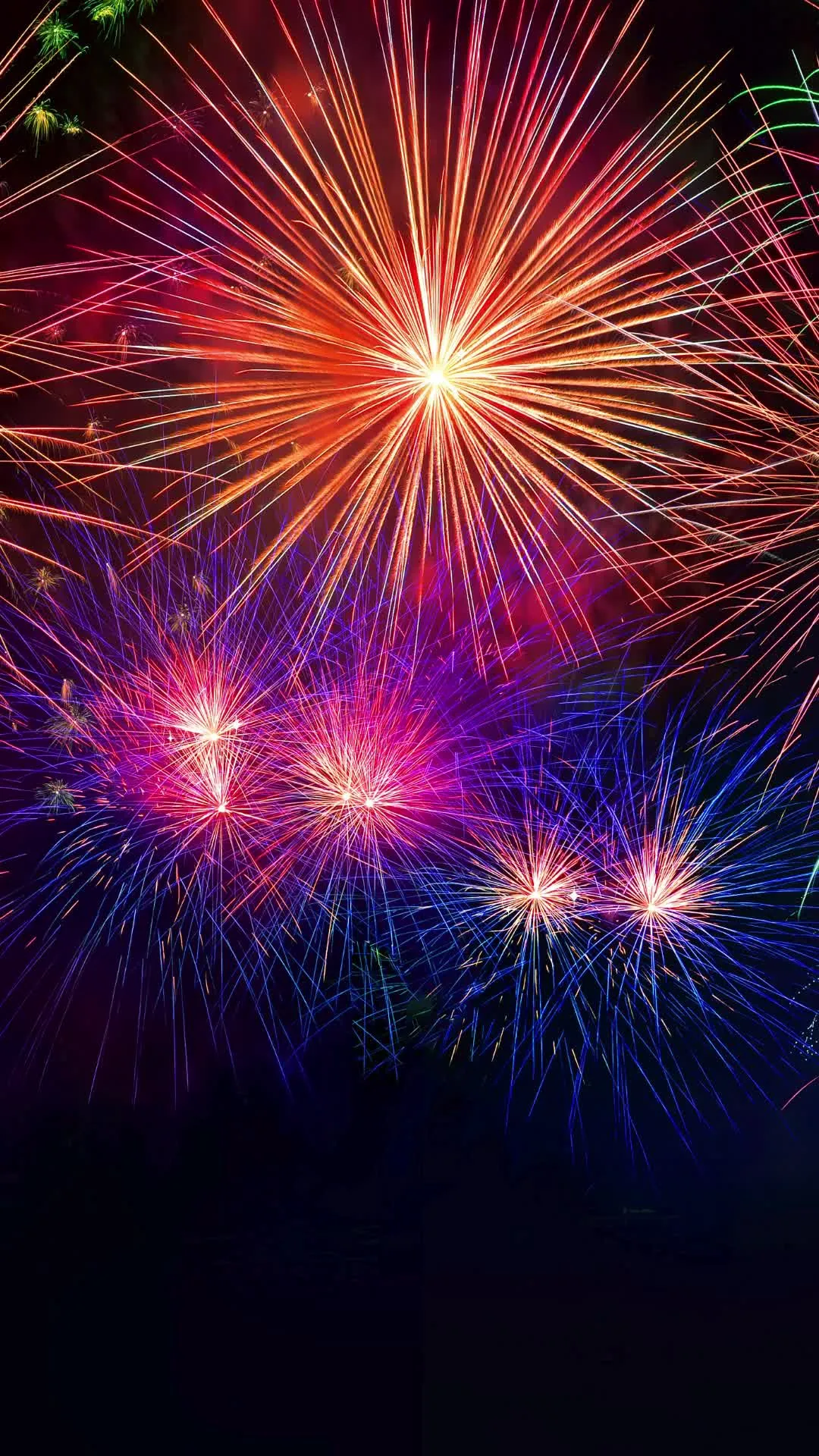 Colorful fireworks exploding in the night sky over the city