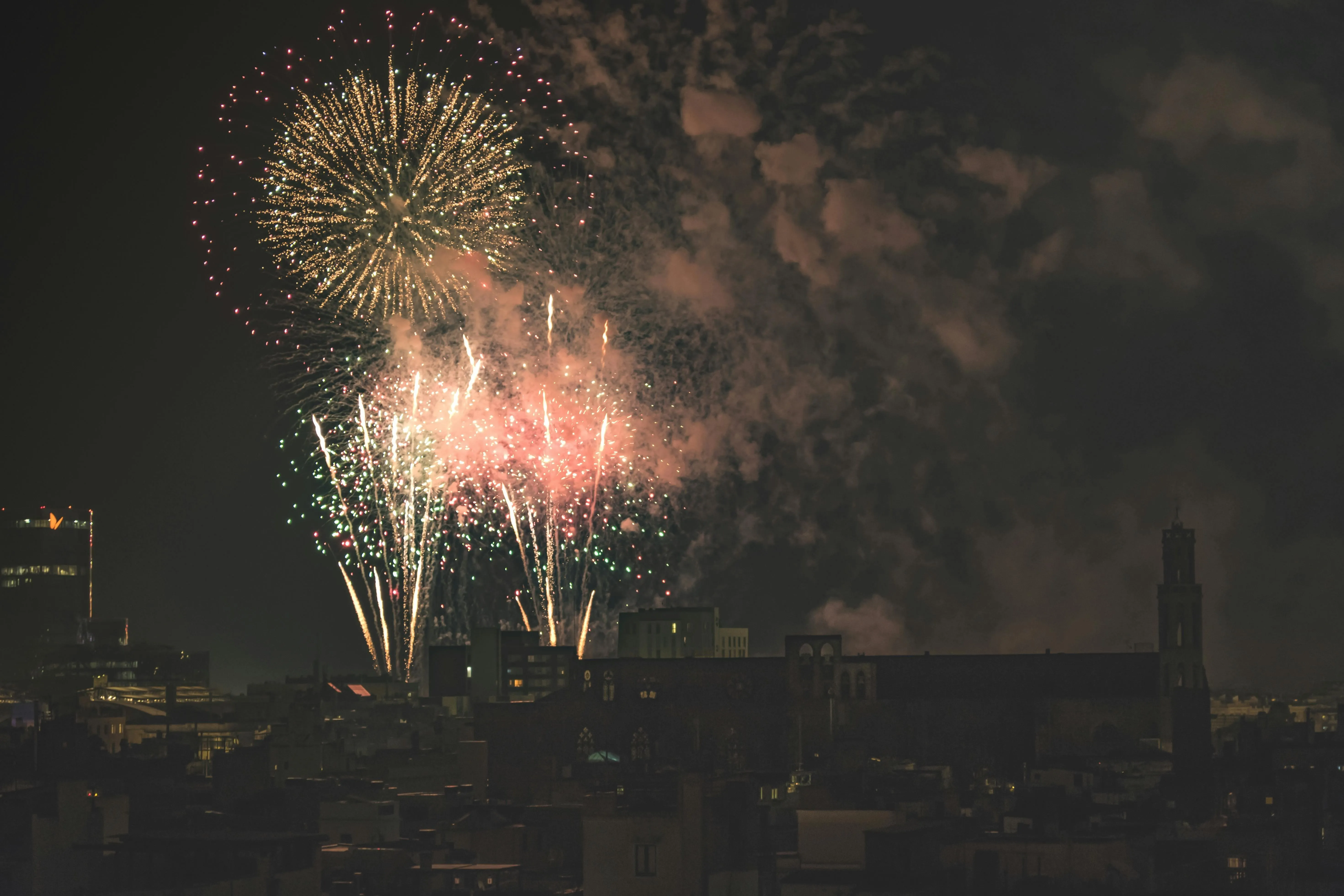 Colorful fireworks lighting up the dark city streets