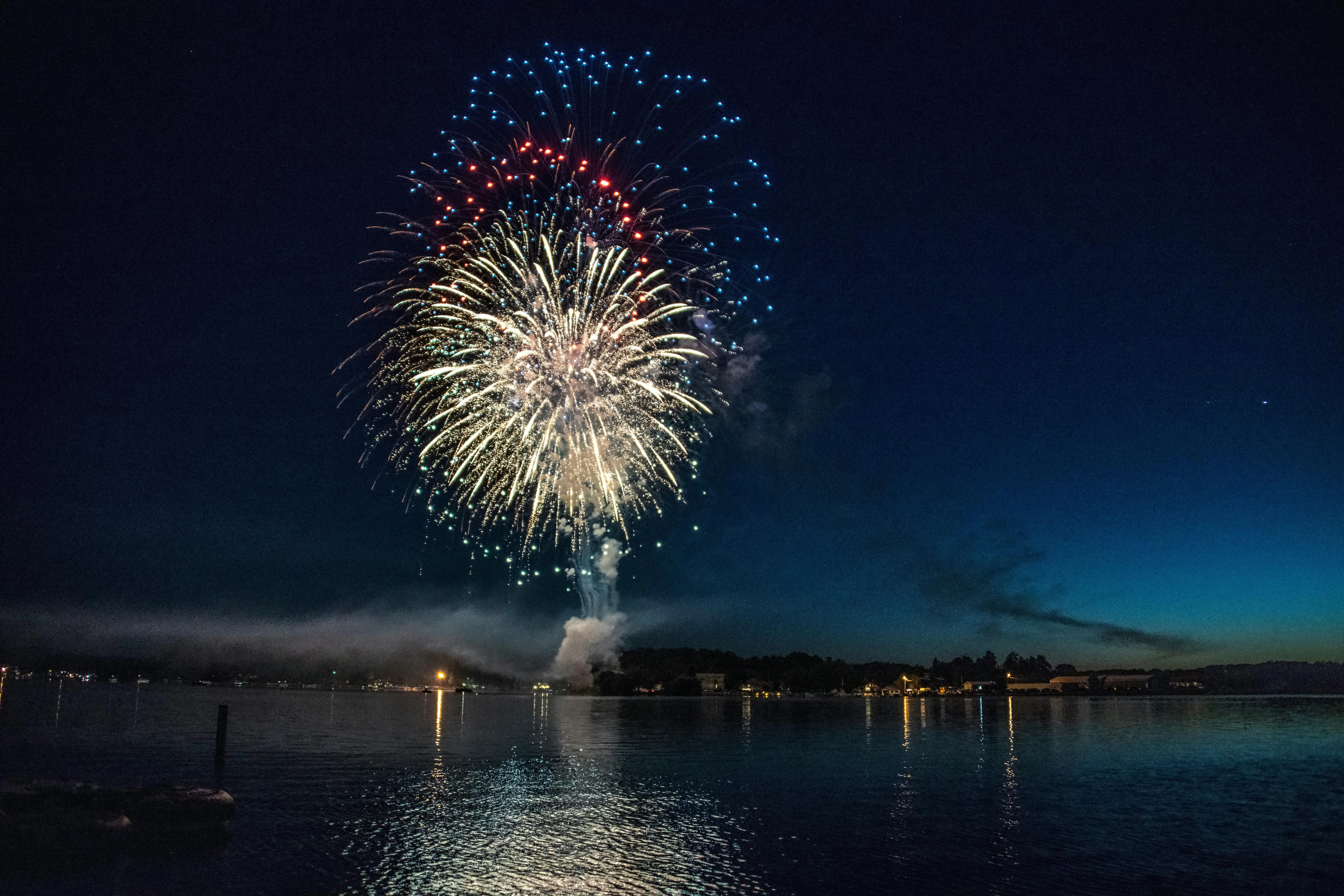 Colorful Fireworks Lighting up the Night Sky over Water