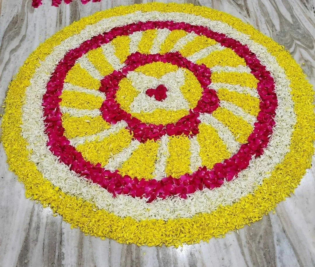 Colourful circular rangoli with yellow red and white petals