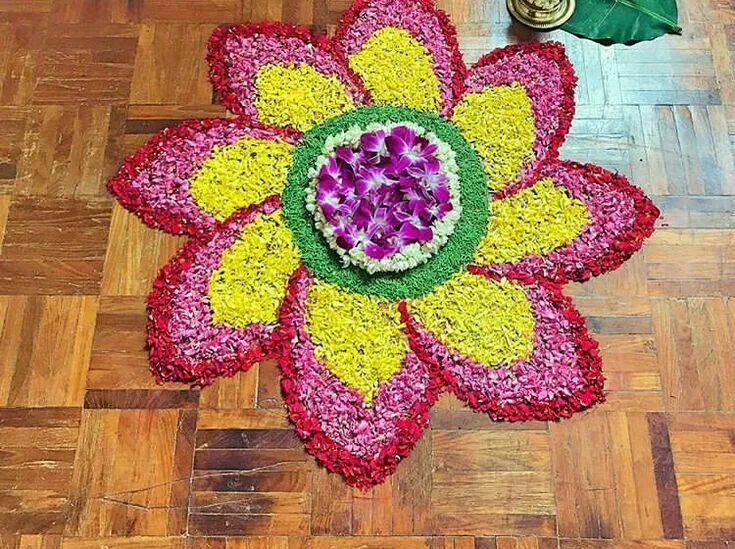 Colourful flower design pookolam with an Orchid Centerpiece