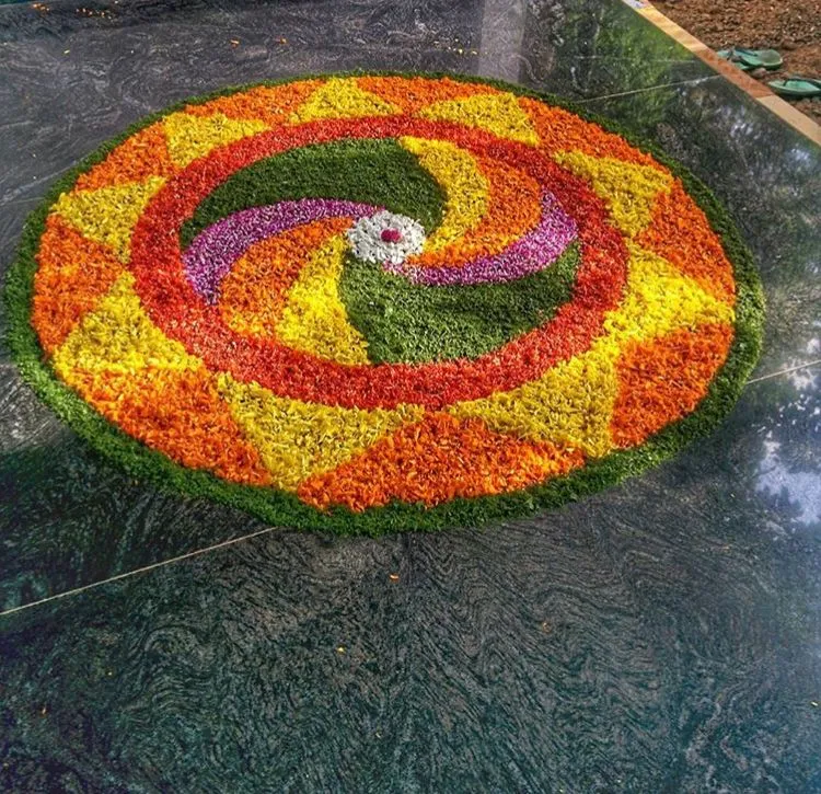 Colourful spiral pookolam design for Onam festival wallpaper
