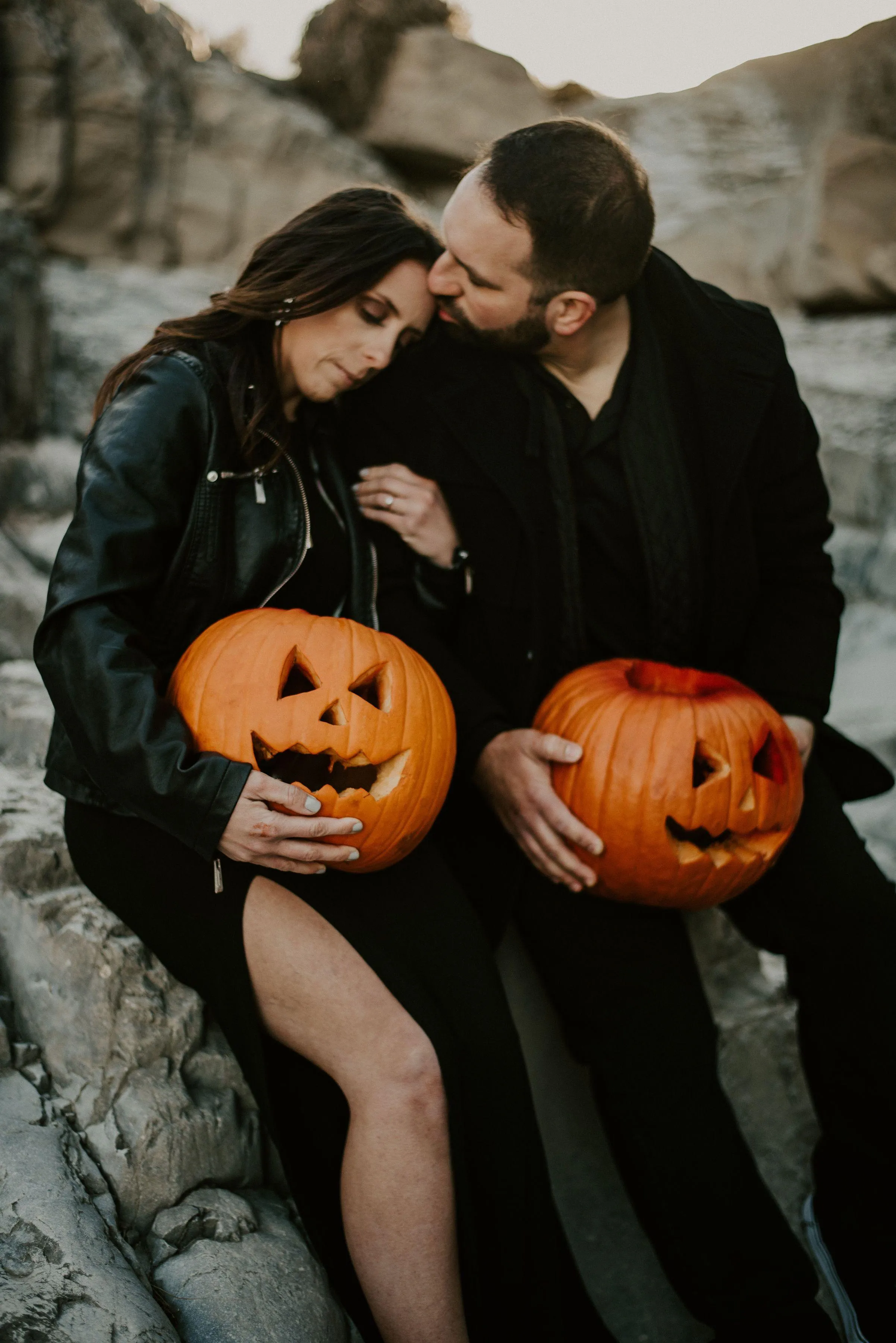 Couple Holding Carved Pumpkins at Halloween Wallpaper