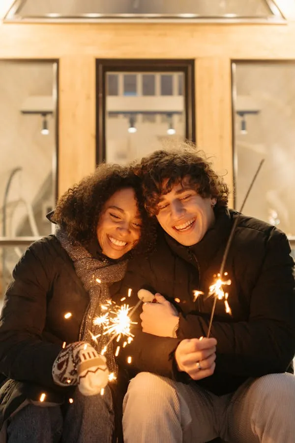 Couple Holding Sparklers Enjoying a Winter Celebration