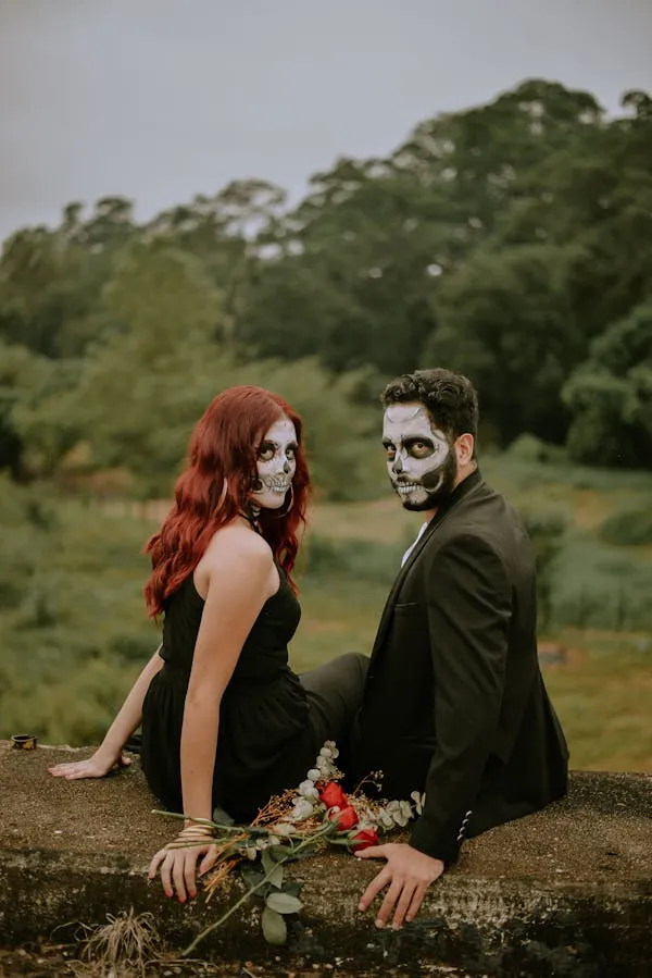 Couple in Halloween Costumes with Skull Makeup Wallpaper