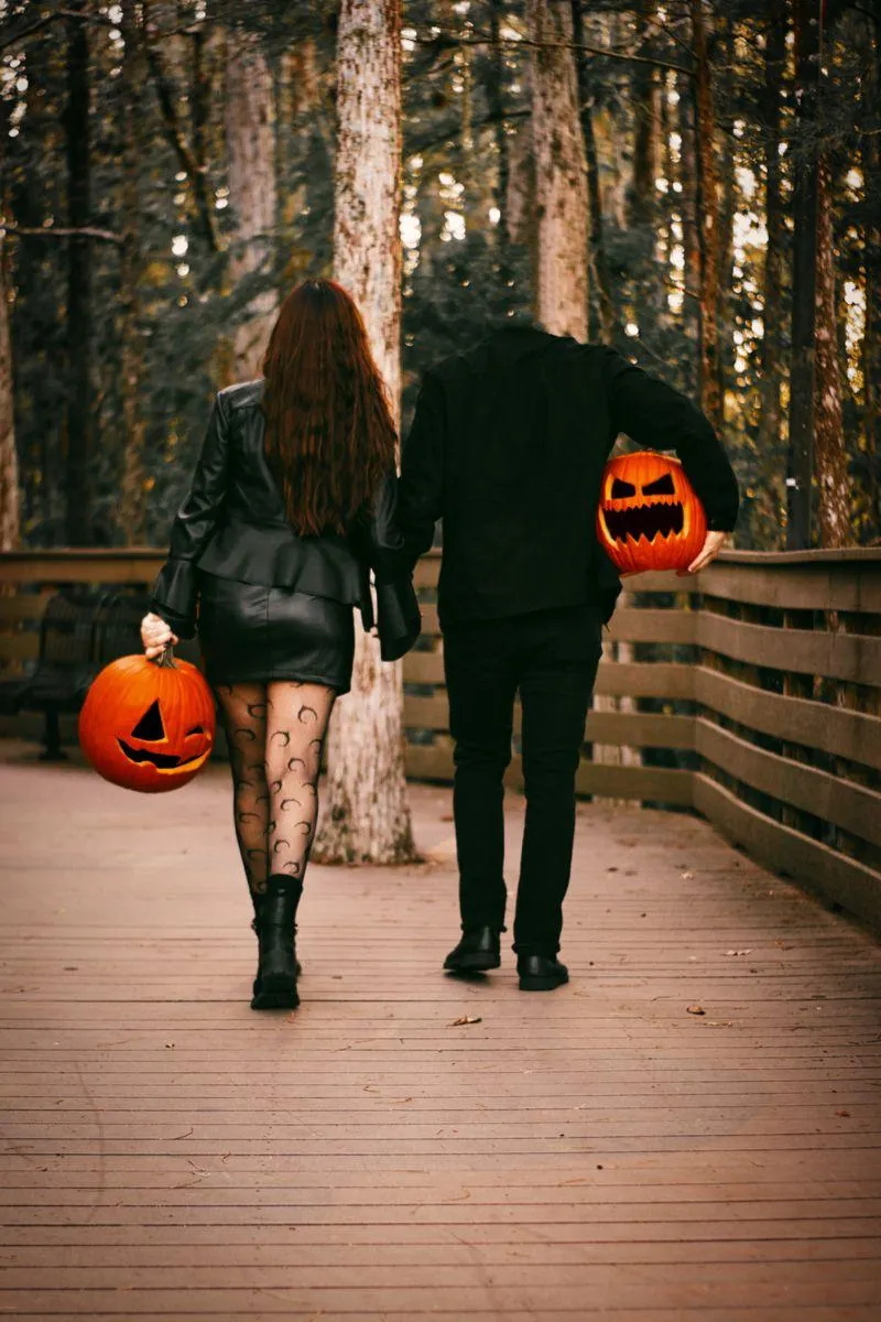 Couple in Halloween Festival Walk with Pumpkin Head Costumes