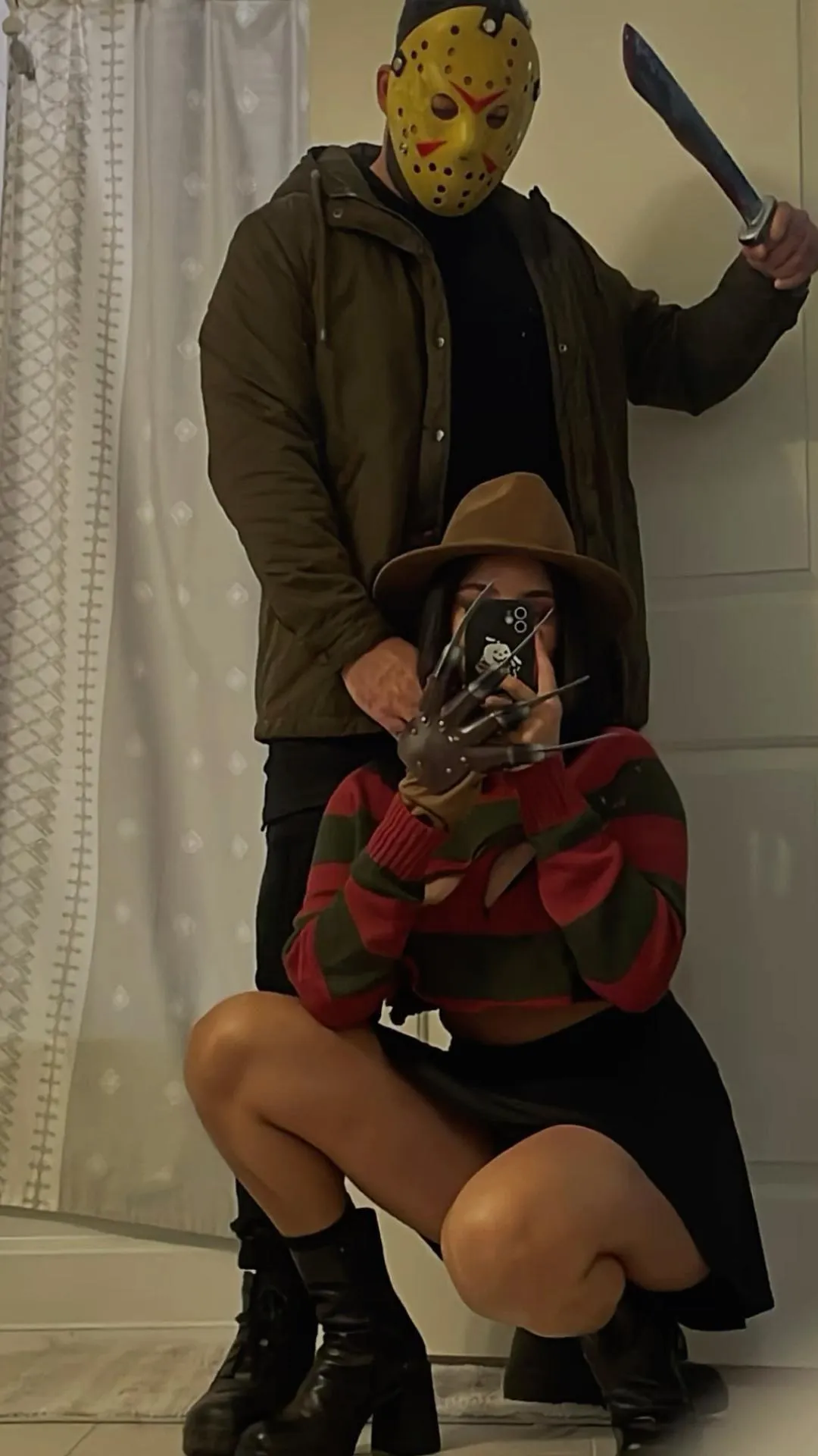 Couple in Horror Costumes at Halloween Party Wallpaper
