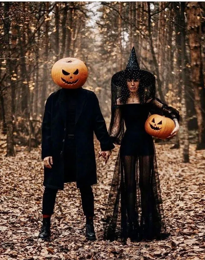 Couple in Pumpkin and Witch Costumes for Halloween Festival