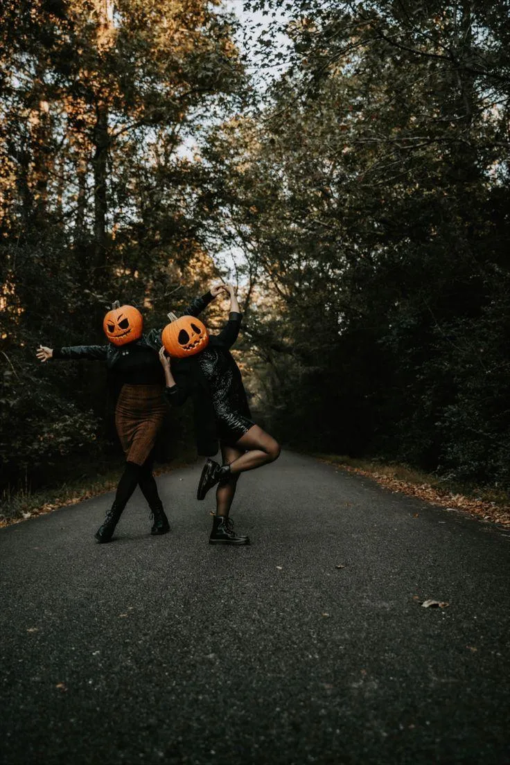 Couple in Pumpkin Heads posiung with the Woods Wallpaper