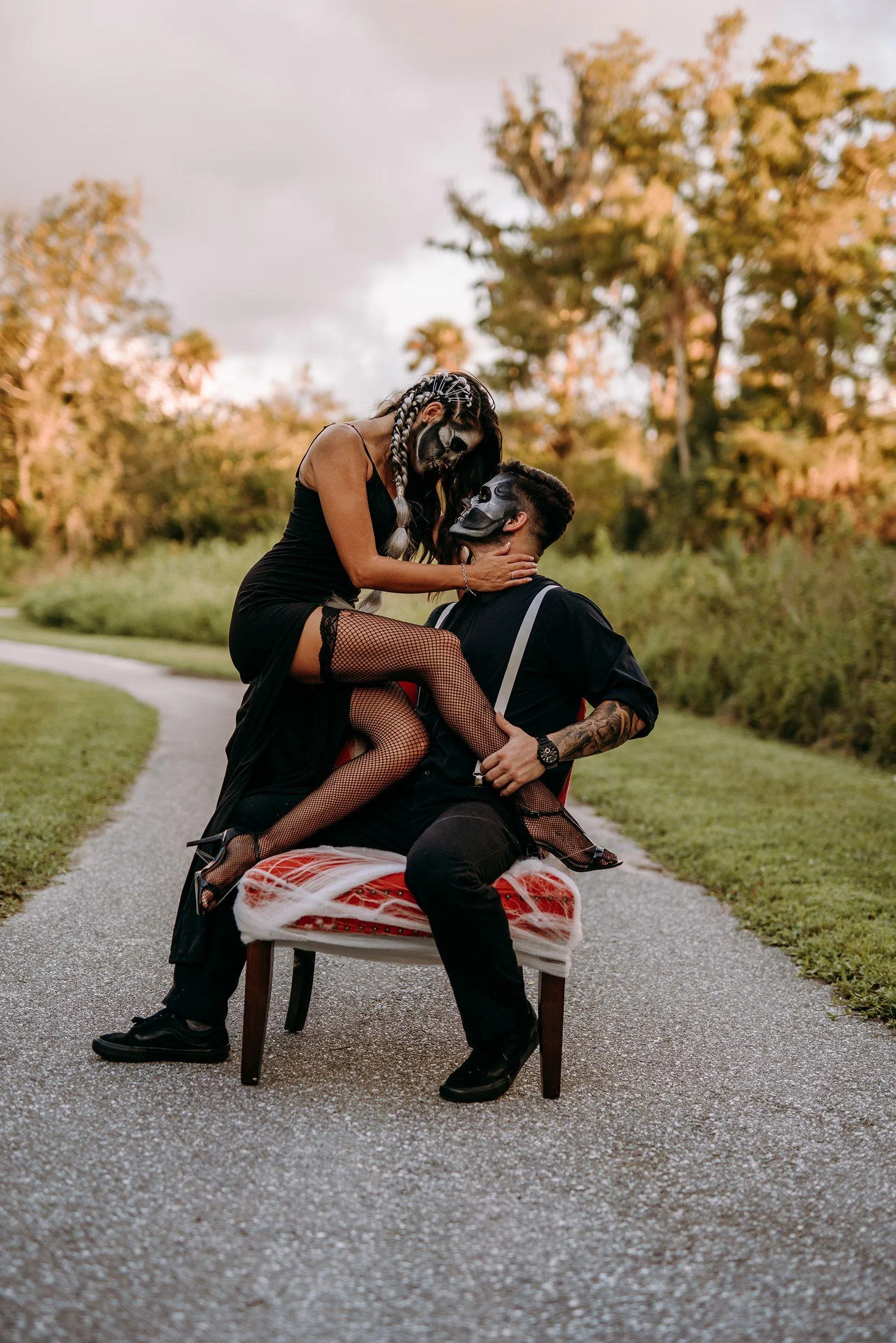 Couple Sitting on Bench During Halloween Celebration