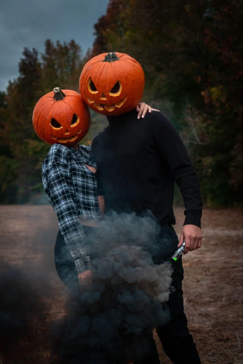 Couple standing on a forest settiing with black soke image