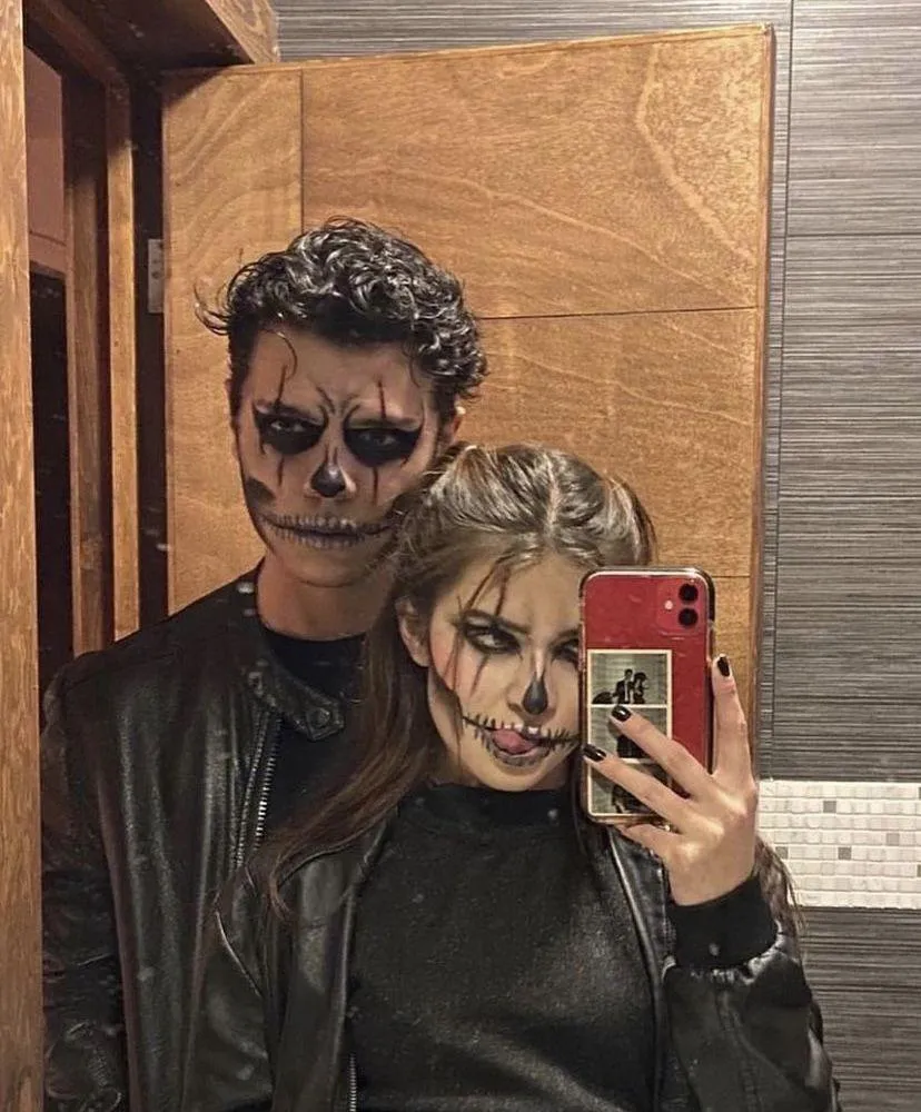 Couple Taking Mirror Selfie with Detailed Face Paint image