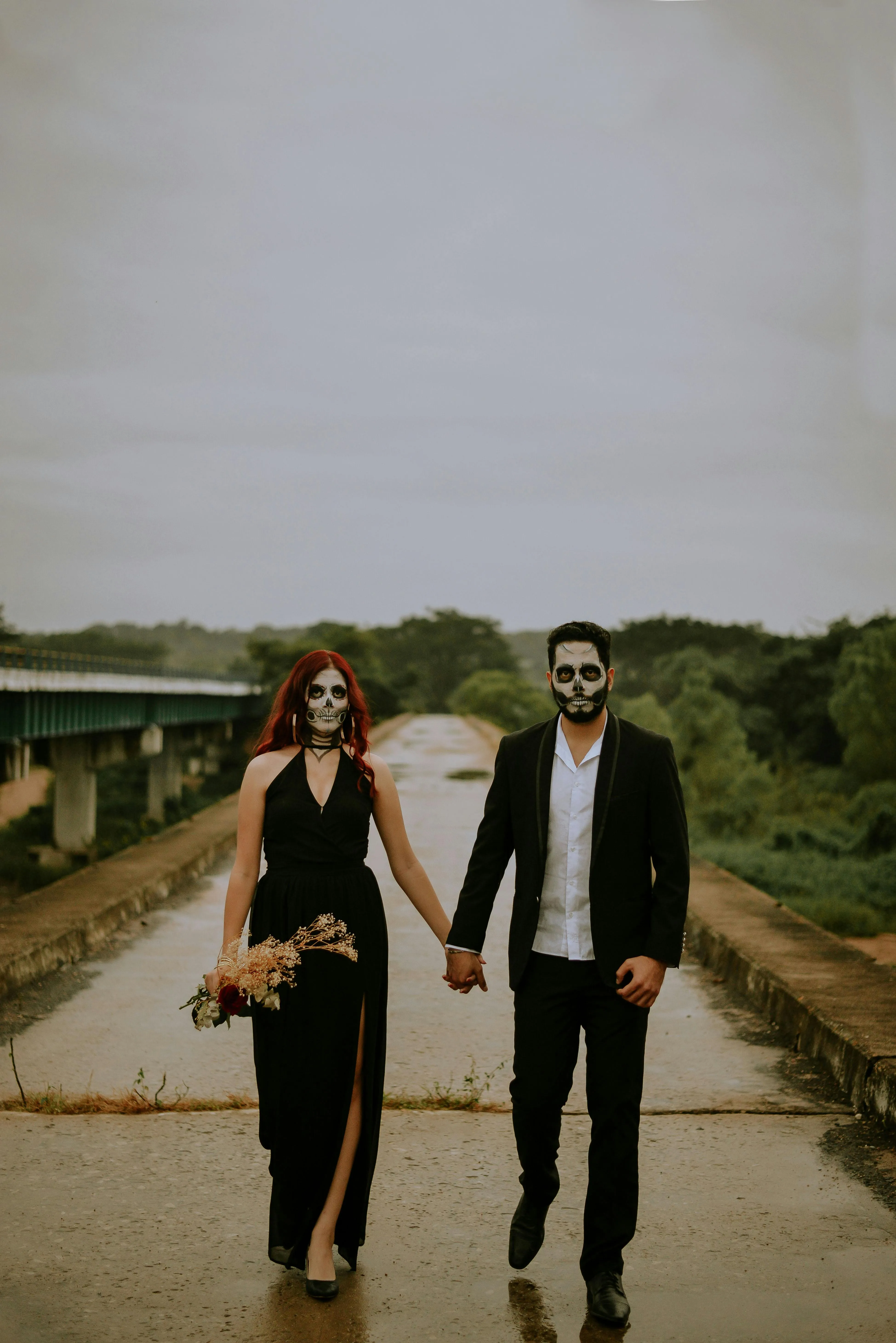 Couple Wearing Halloween Costumes on a path Wallpaper