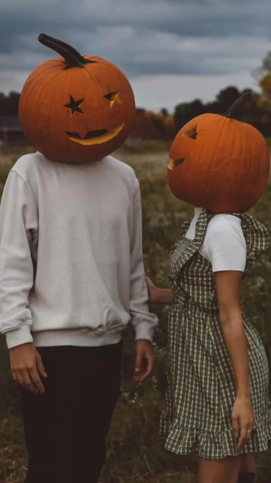 Couple Wearing Pumpkin Head Masks at Halloween Festival