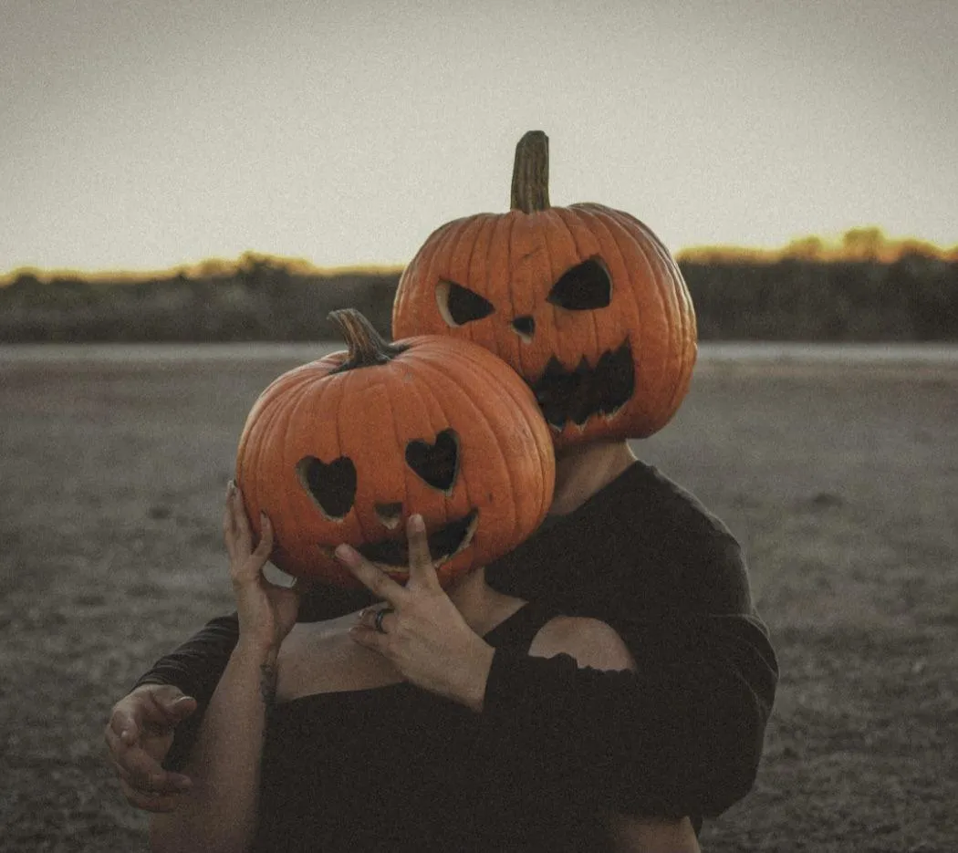 Couple Wearing Pumpkin Head Masks posing for Camera