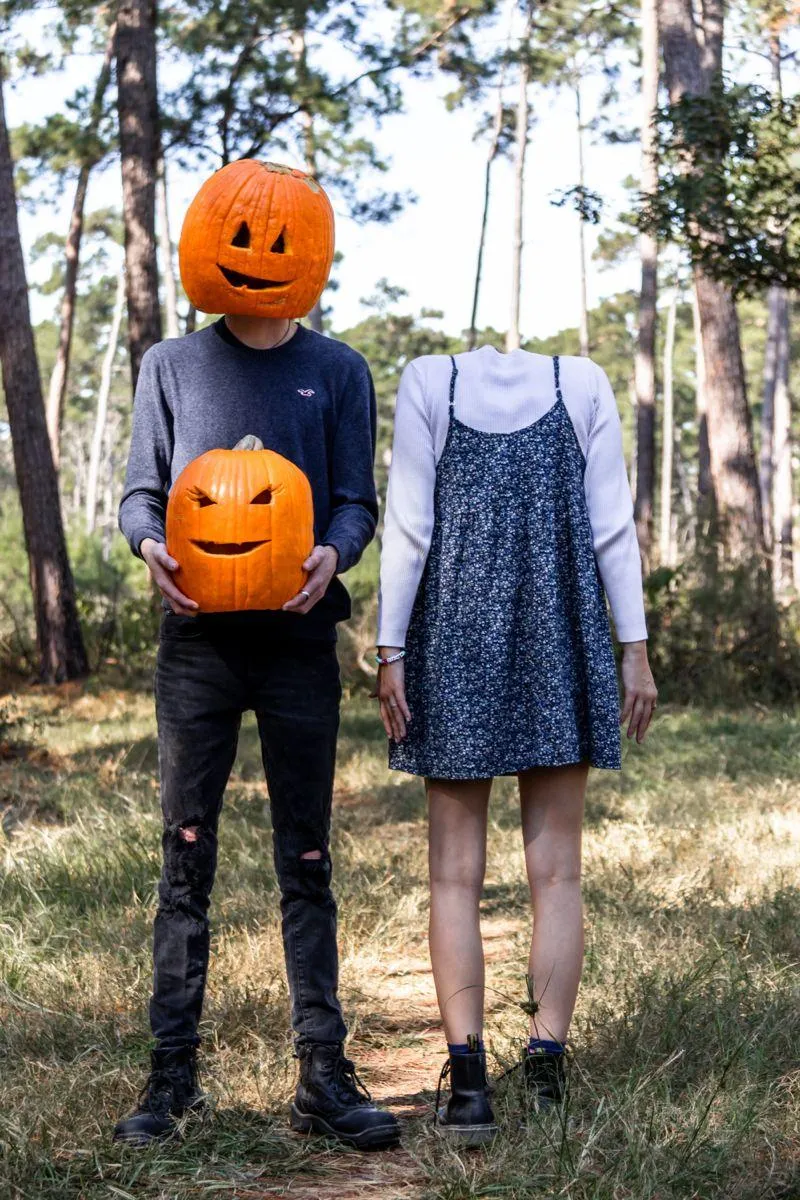 Couple Wearing Pumpkin Heads at Outdoor Halloween Festival