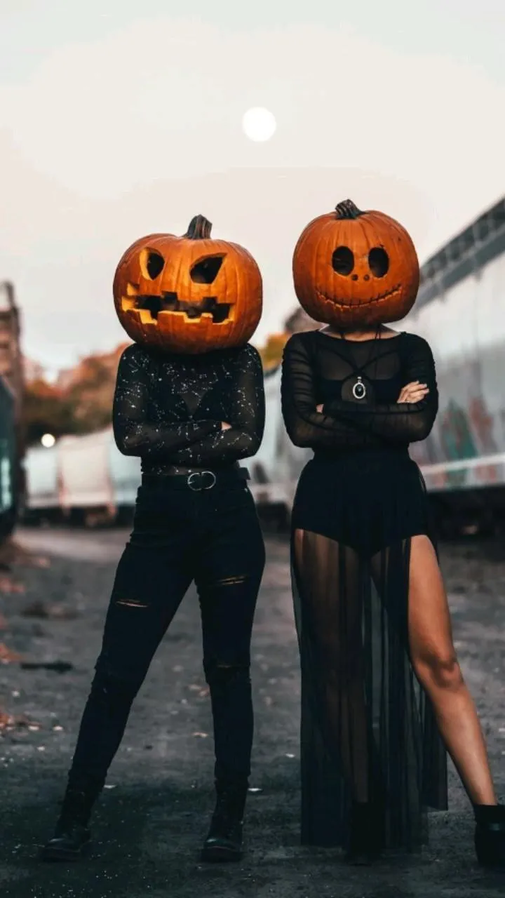 Couple Wearing Pumpkin Heads for Halloween Festivities