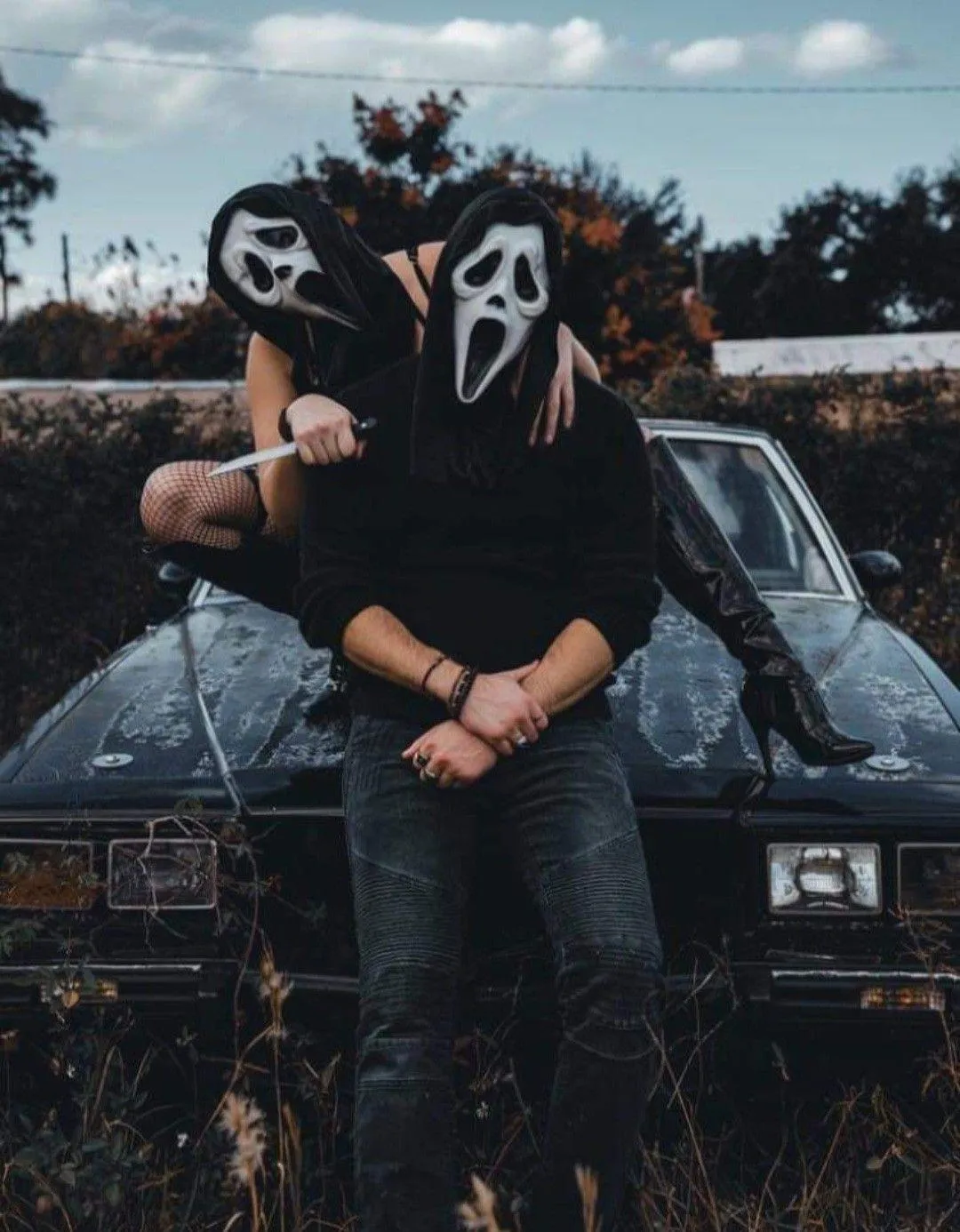 Couple Wearing Scream Masks at Halloween Car Show image