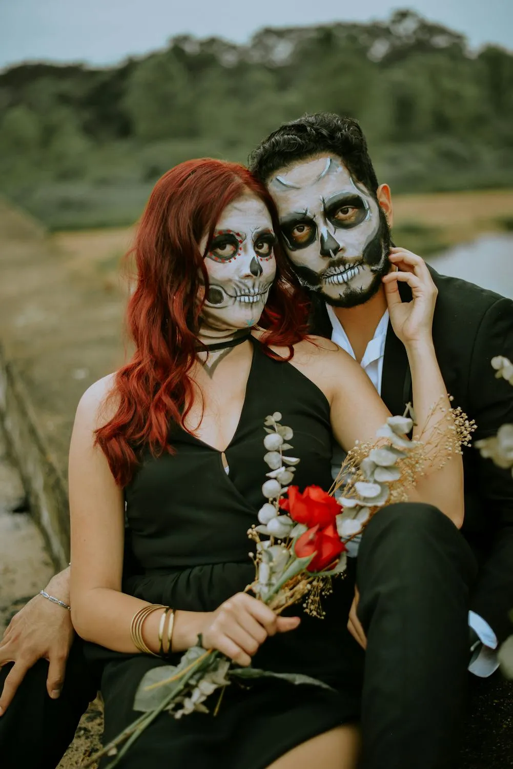Couple with Artistic Halloween Face Paint and Costumes