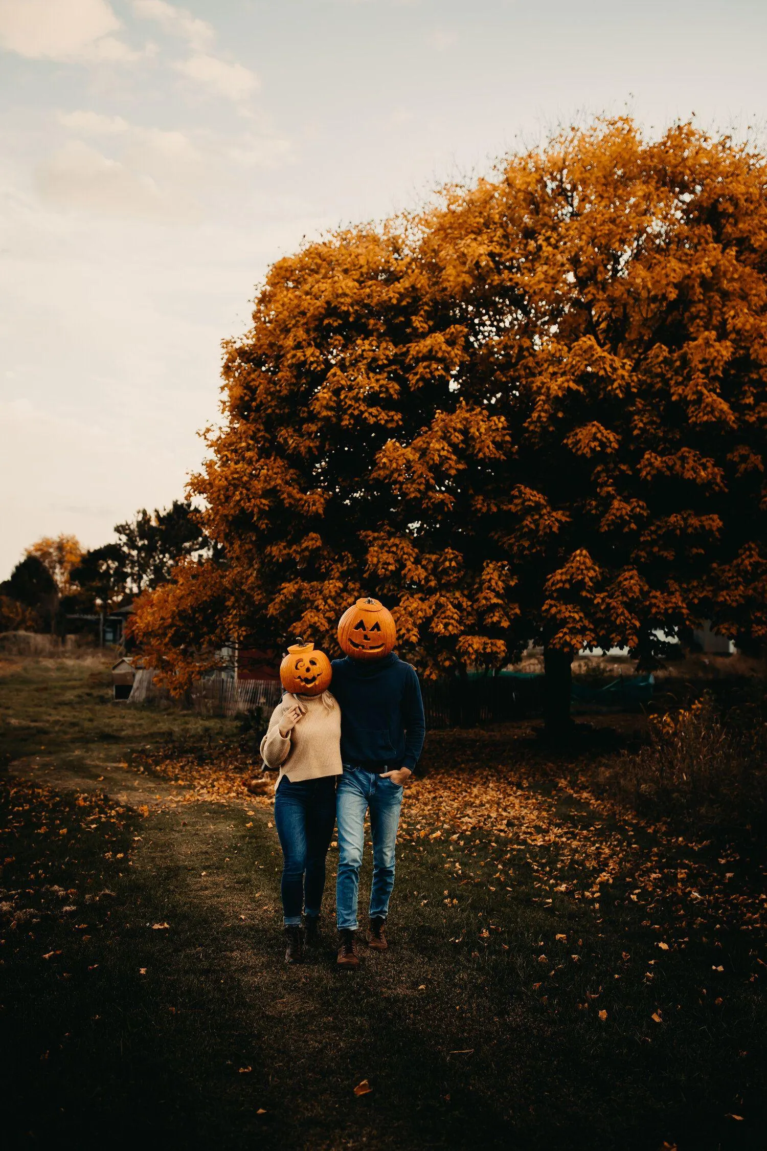 Couple with Pumpkin Decorations in Orange Forest Path