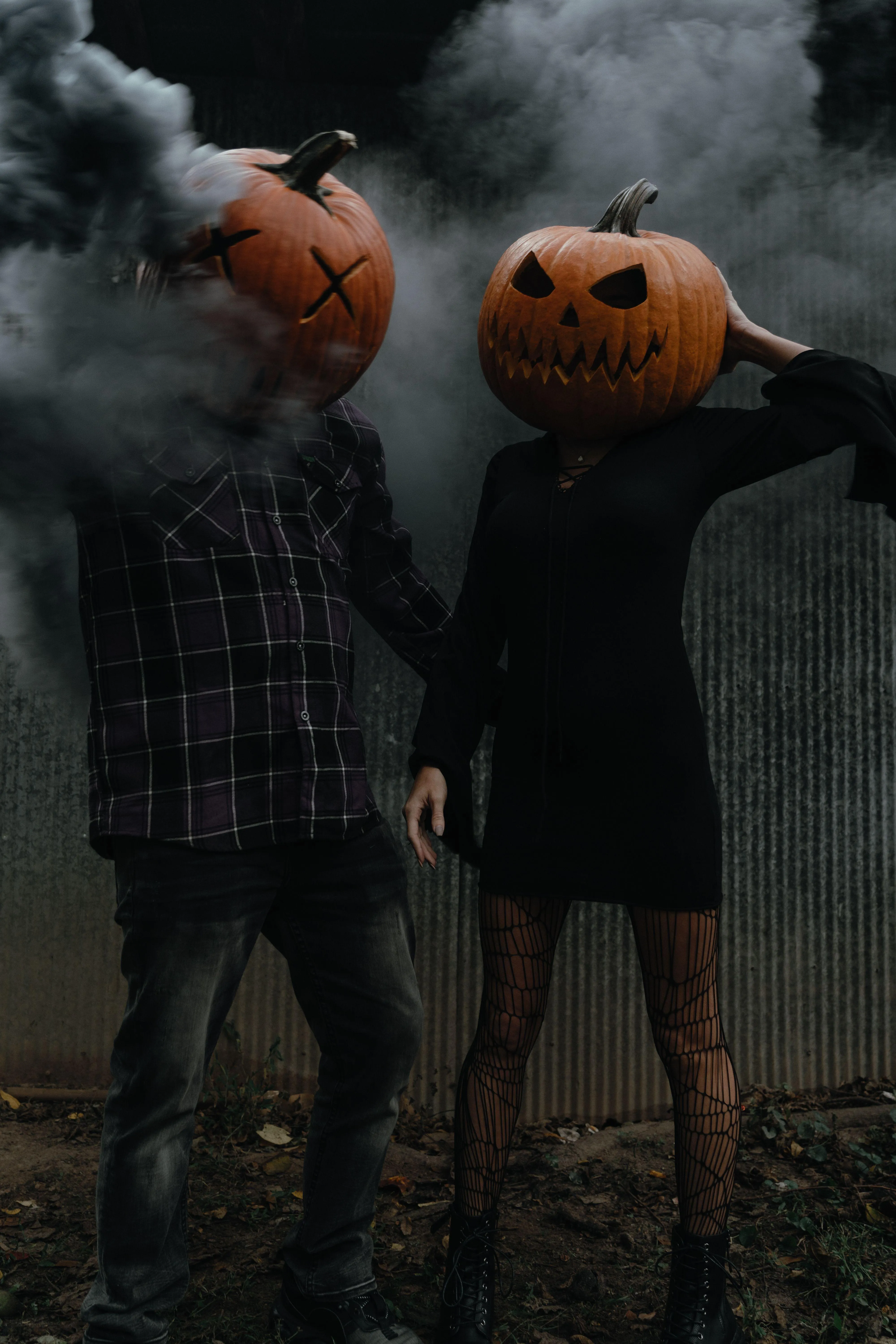 Couple with Pumpkin Heads Celebrating Halloween with smoke
