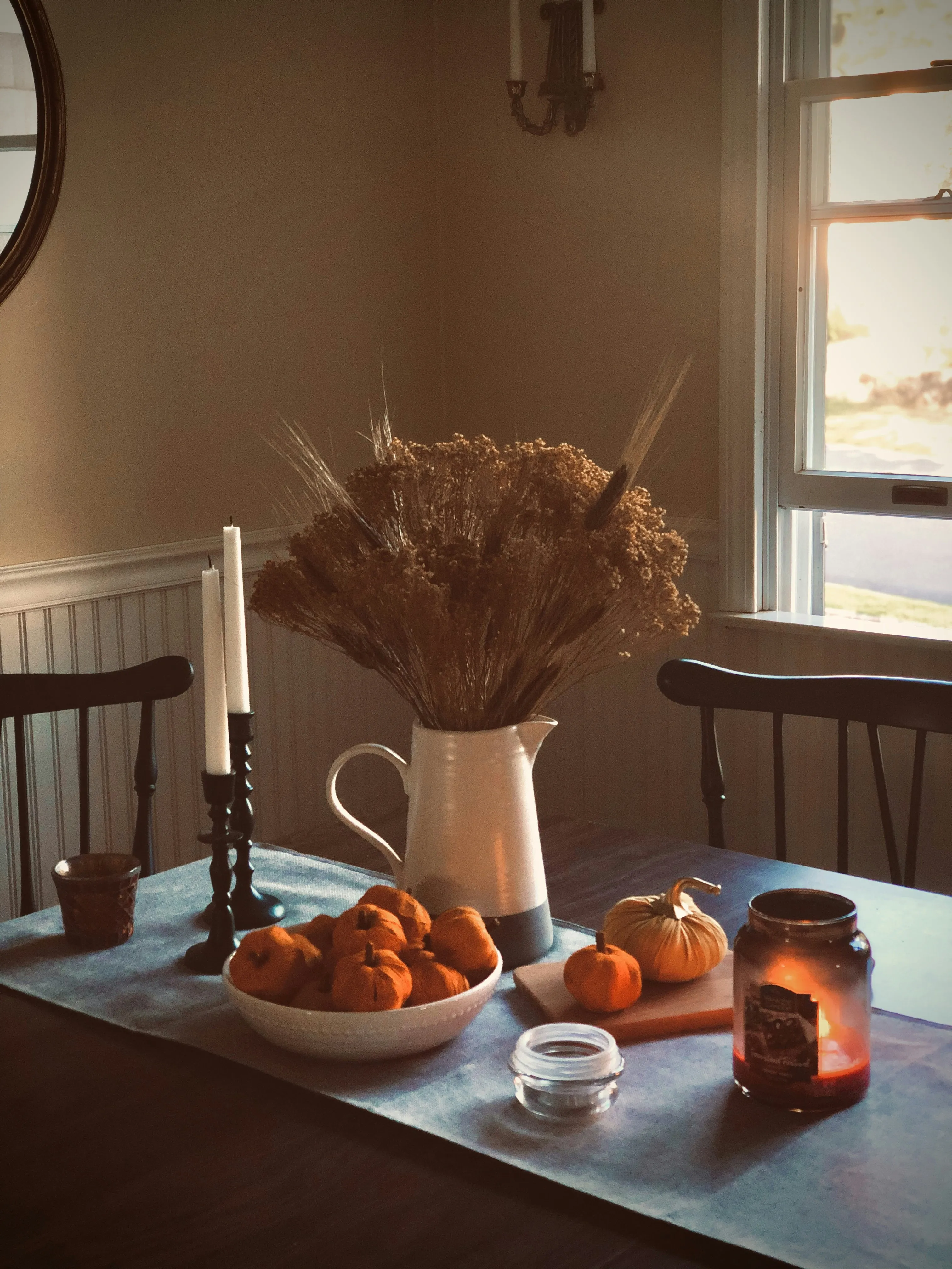 Cozy Autumn Table Setup with Pumpkin Decor Wallpaper