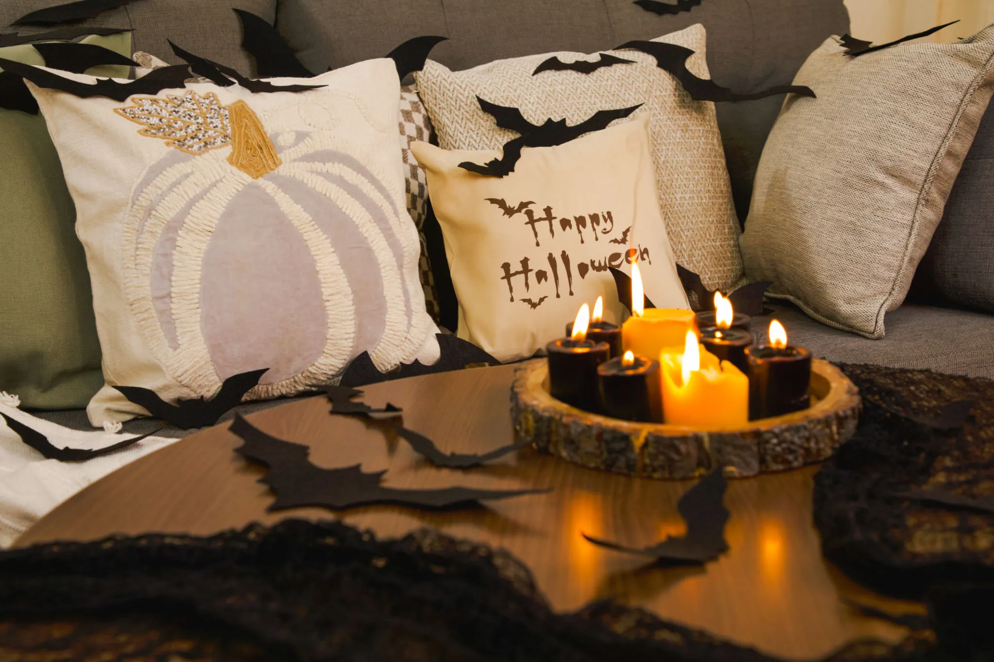 Cozy Halloween Couch Decor with Pillows and Pumpkin Candles