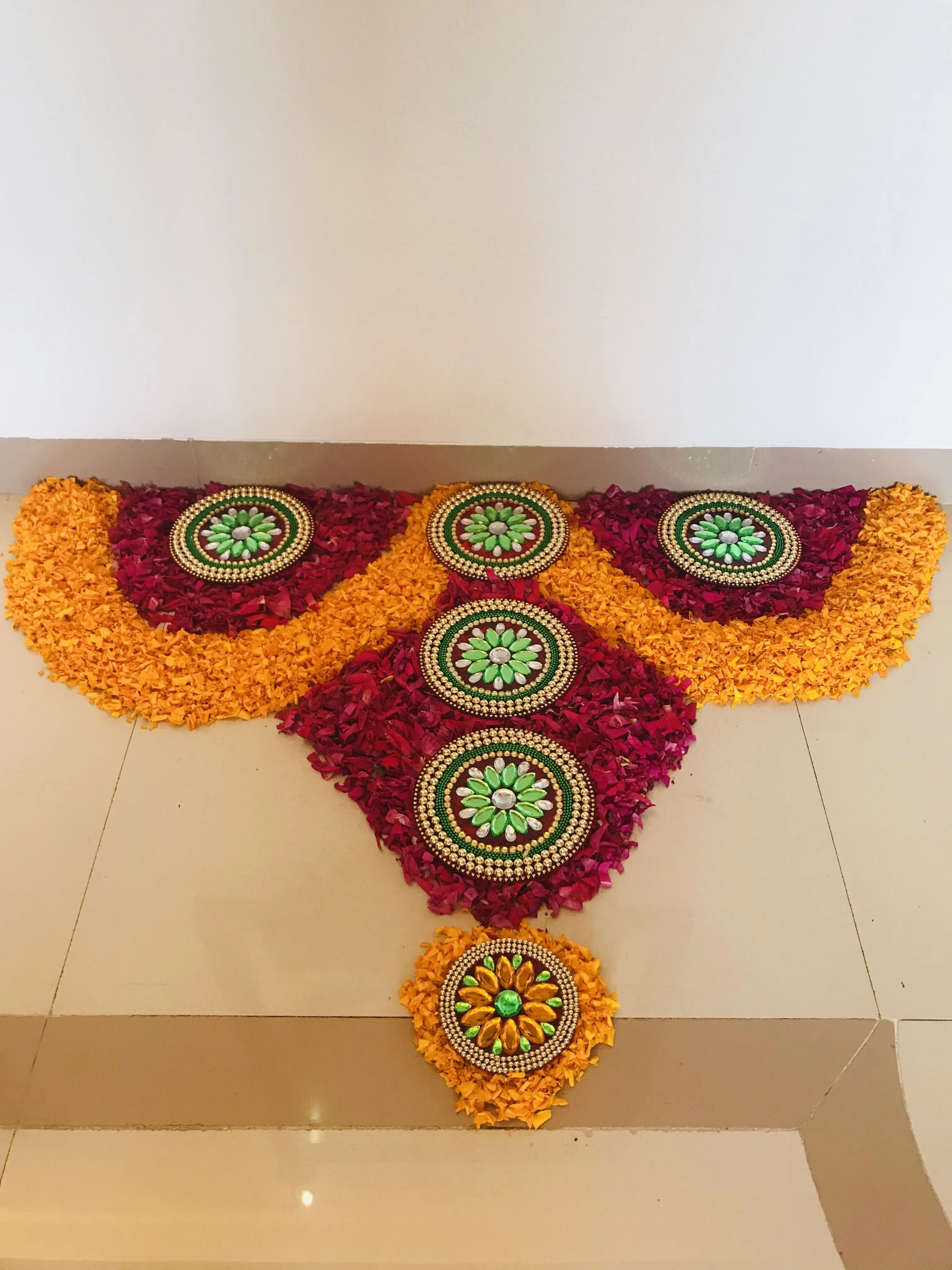 Creative half circle pookolam with decorative stones image