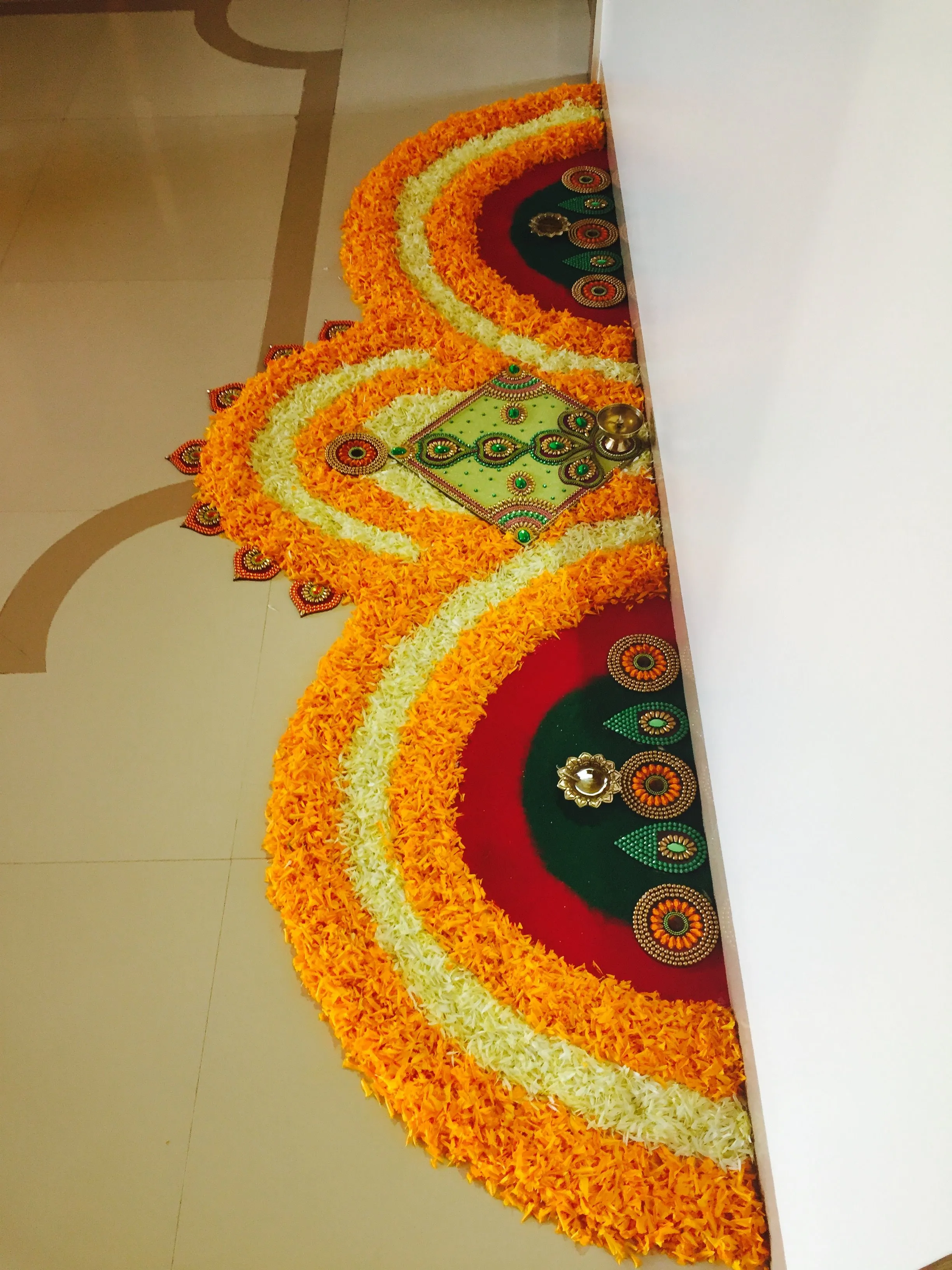 Creative half circle rangoli with colourful stone details