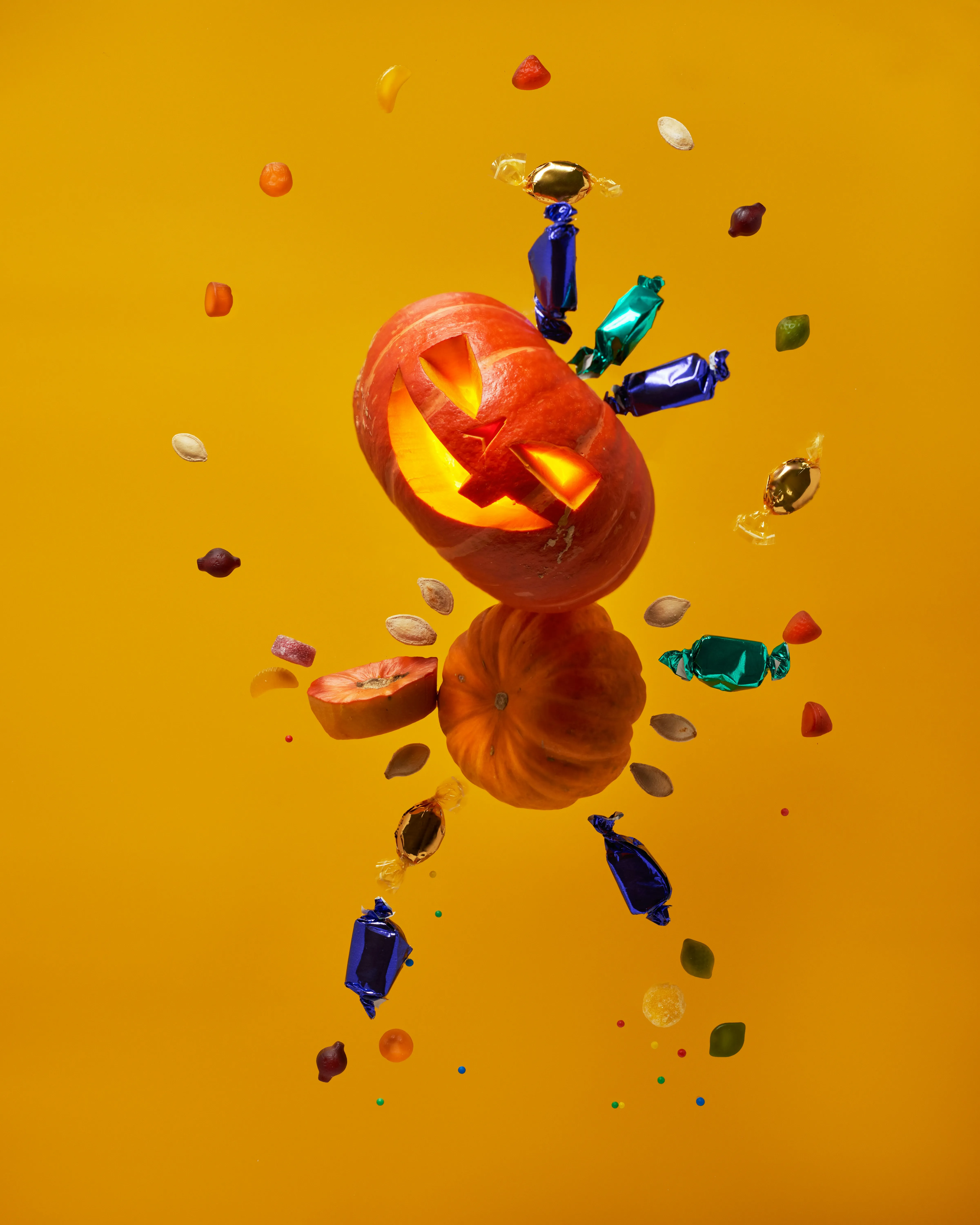 Creative Pumpkin Explosion Artwork on Yellow Background