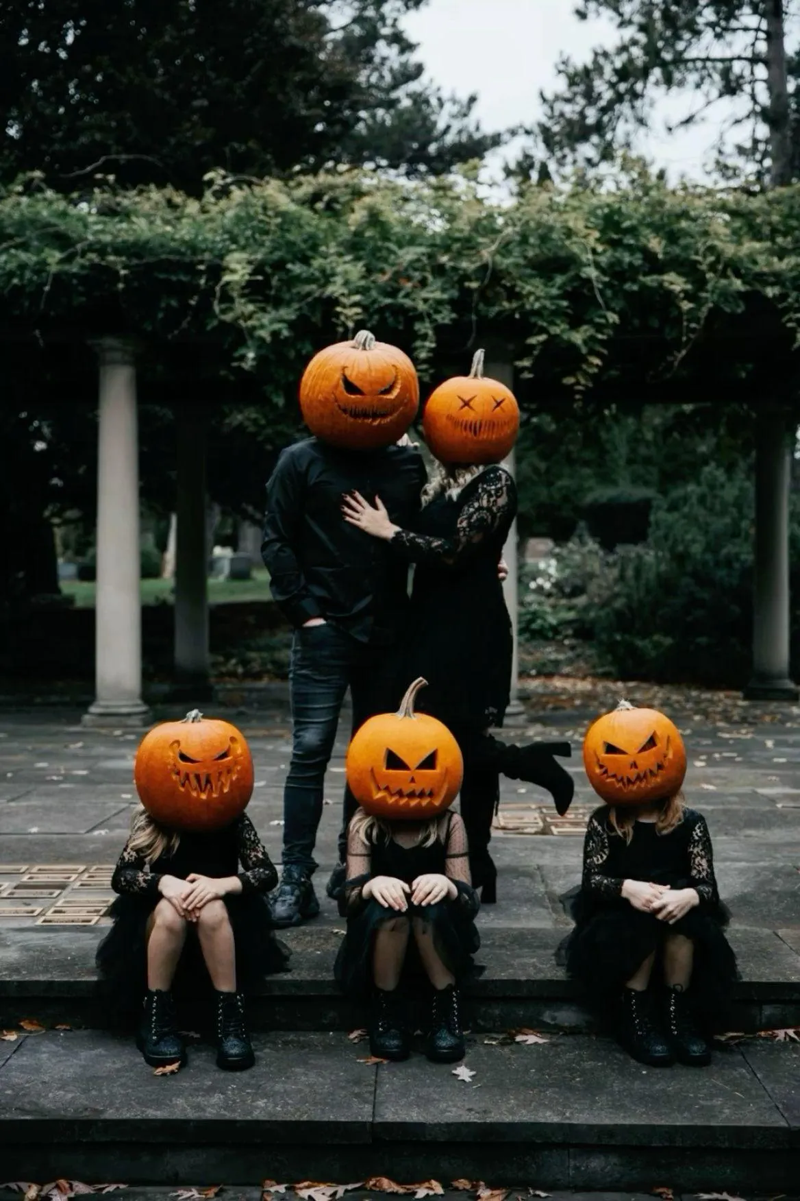 Creepy Cute Pumpkin Head Family Posing Outdoors image