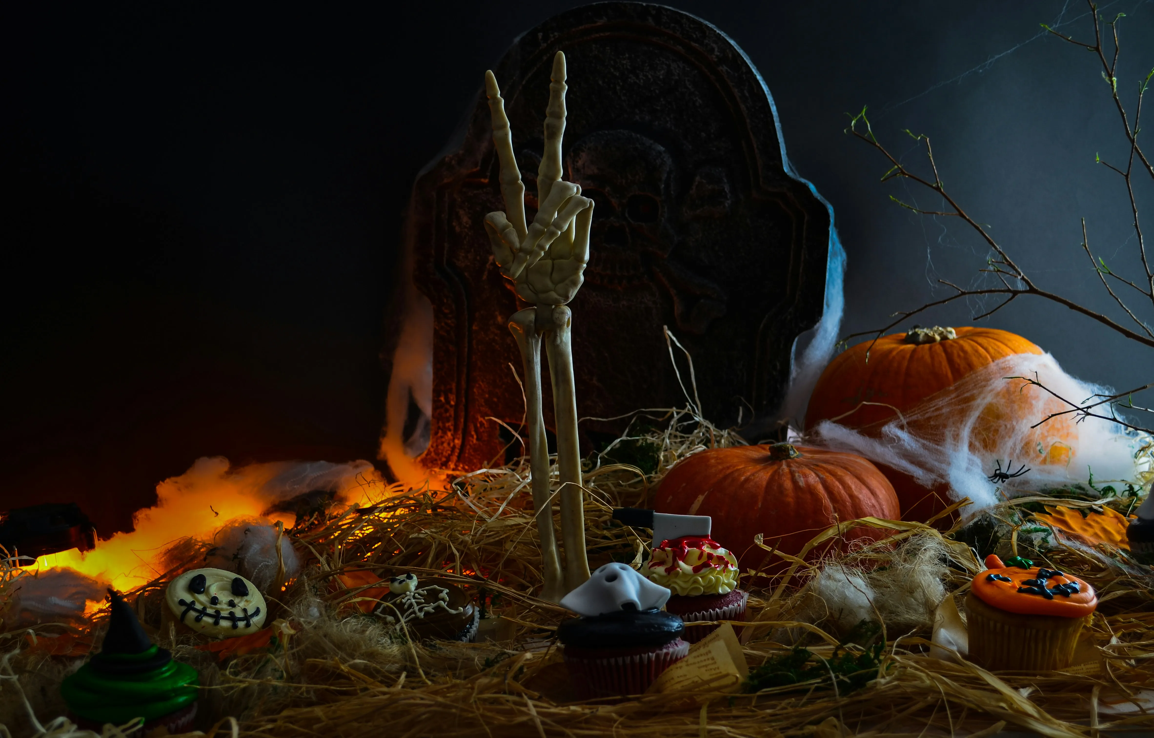 Creepy Halloween Scene with Skeleton and Pumpkins Wallpaper