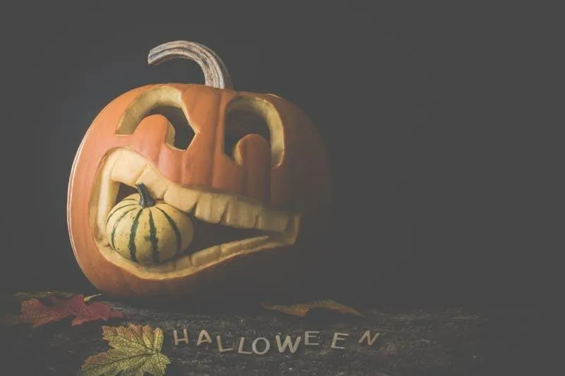 Creepy Pumpkin with Wicked Face Carving in Dim Light