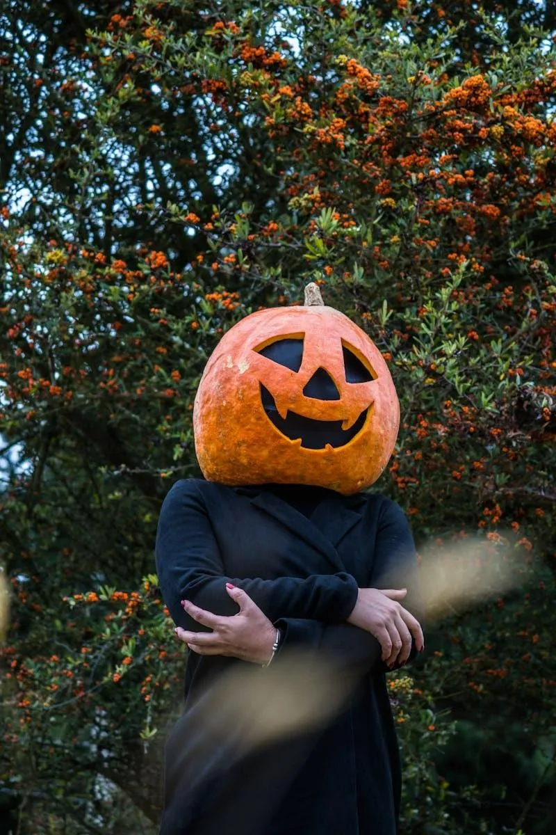 Crossed Arms Pumpkin Head Among Autumn Leaves Wallpaper
