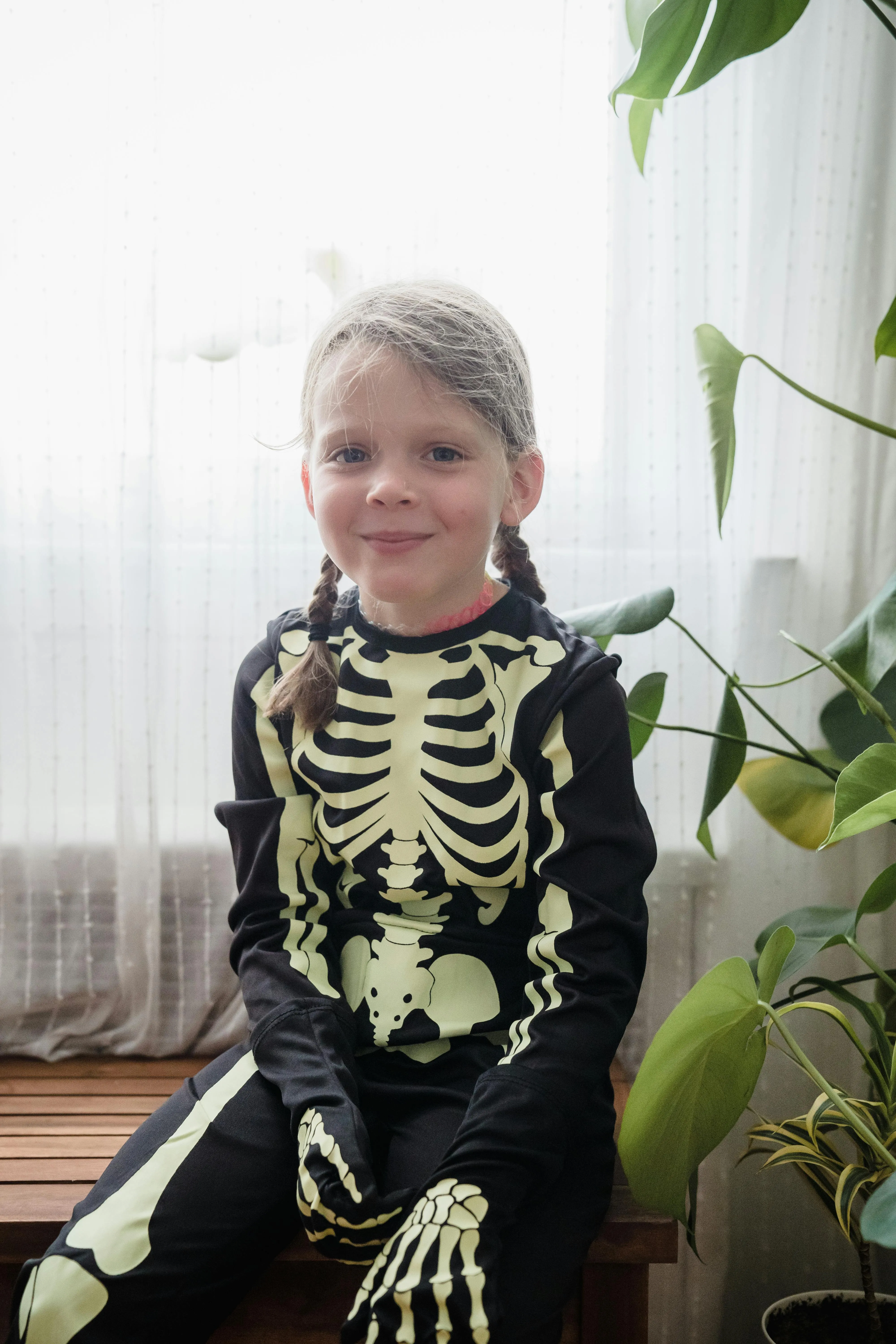 Cute Child in Skeleton Costume for Halloween Party image