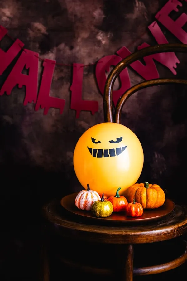 Cute Painted Pumpkin on Halloween Table Setup Wallpaper