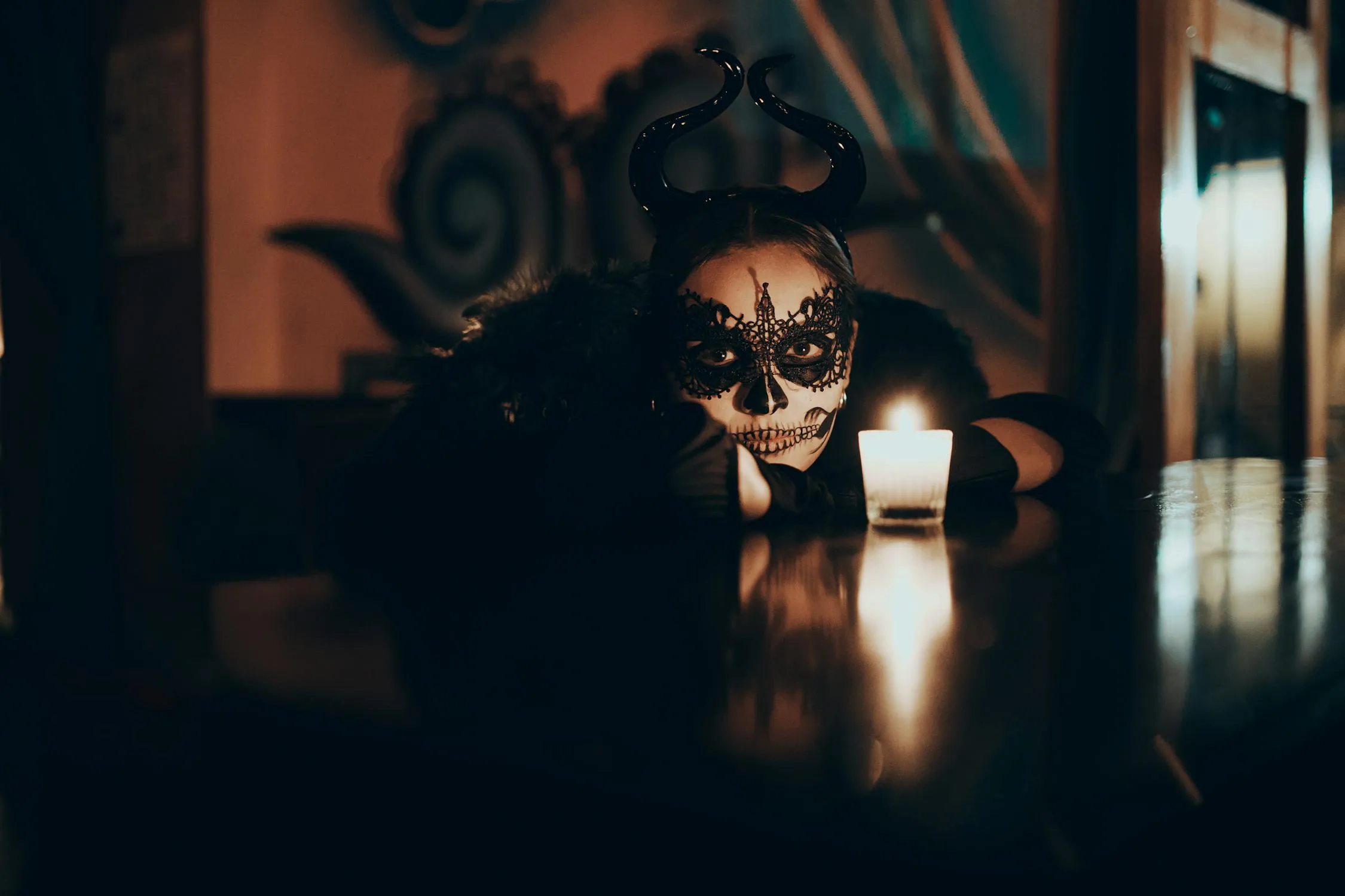 Dark Gothic Woman with Skull Face Paint and Candlelight