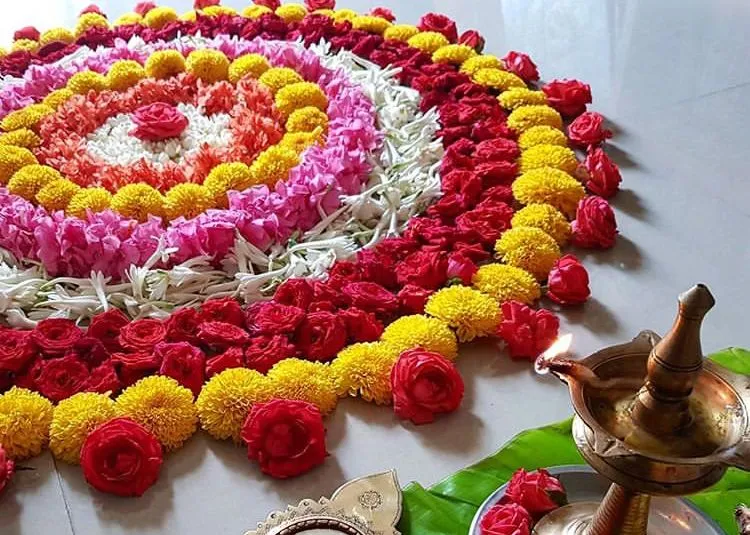 Detailed side view of Onam pookolam with a brass lamp image