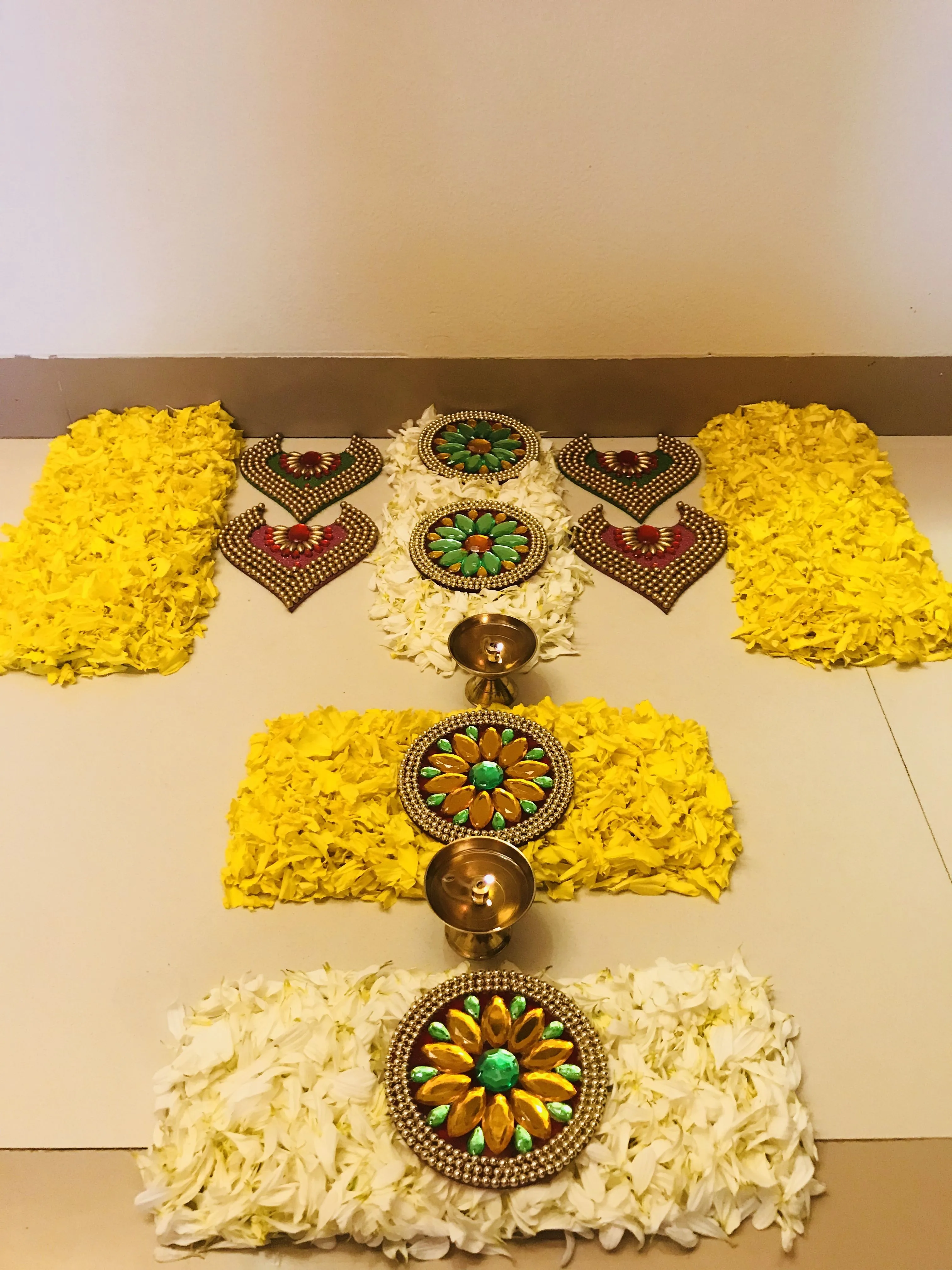 Doorstep Decoration with a floral kolam with decorative bead