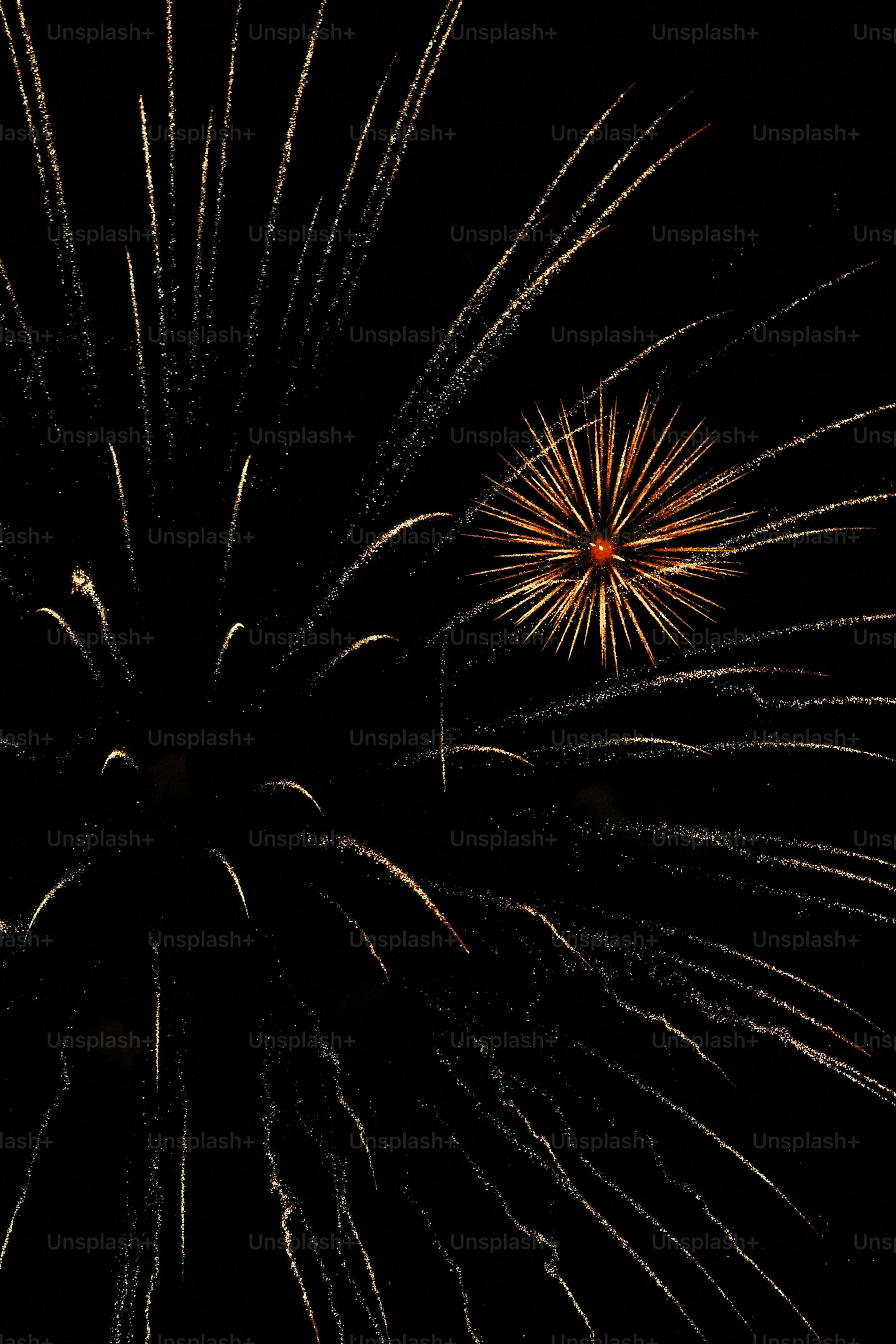 Dramatic fireworks bursting in the night sky Wallpaper
