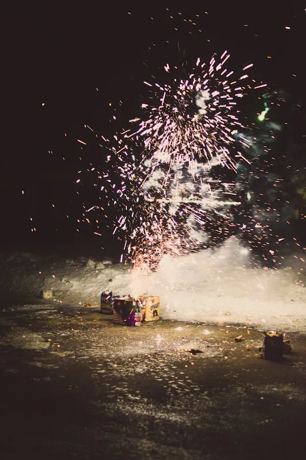 Dramatic Fireworks Erupting in The Distance over the Water