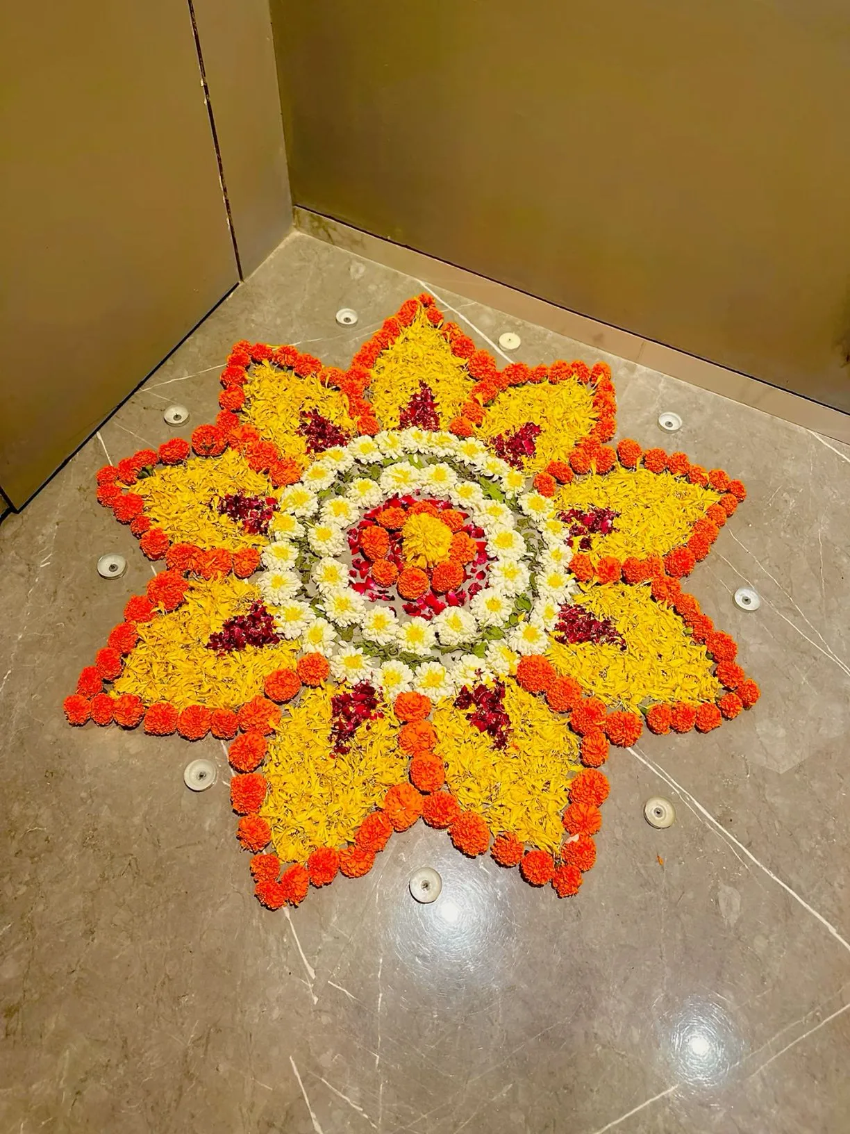 Elegant floral Onam Pookalam with Yellow and Orange Flowers