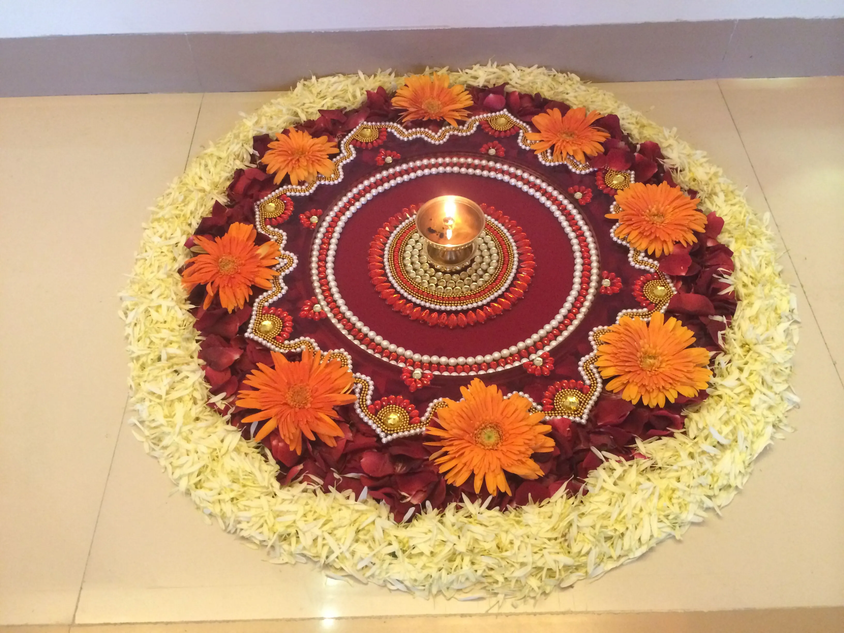 Elegant floral rangoli with petals flowers and beads image