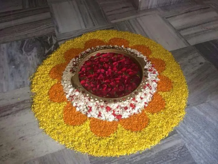 Elegant flower Rangoli with Rose petals and Brass Bowl image